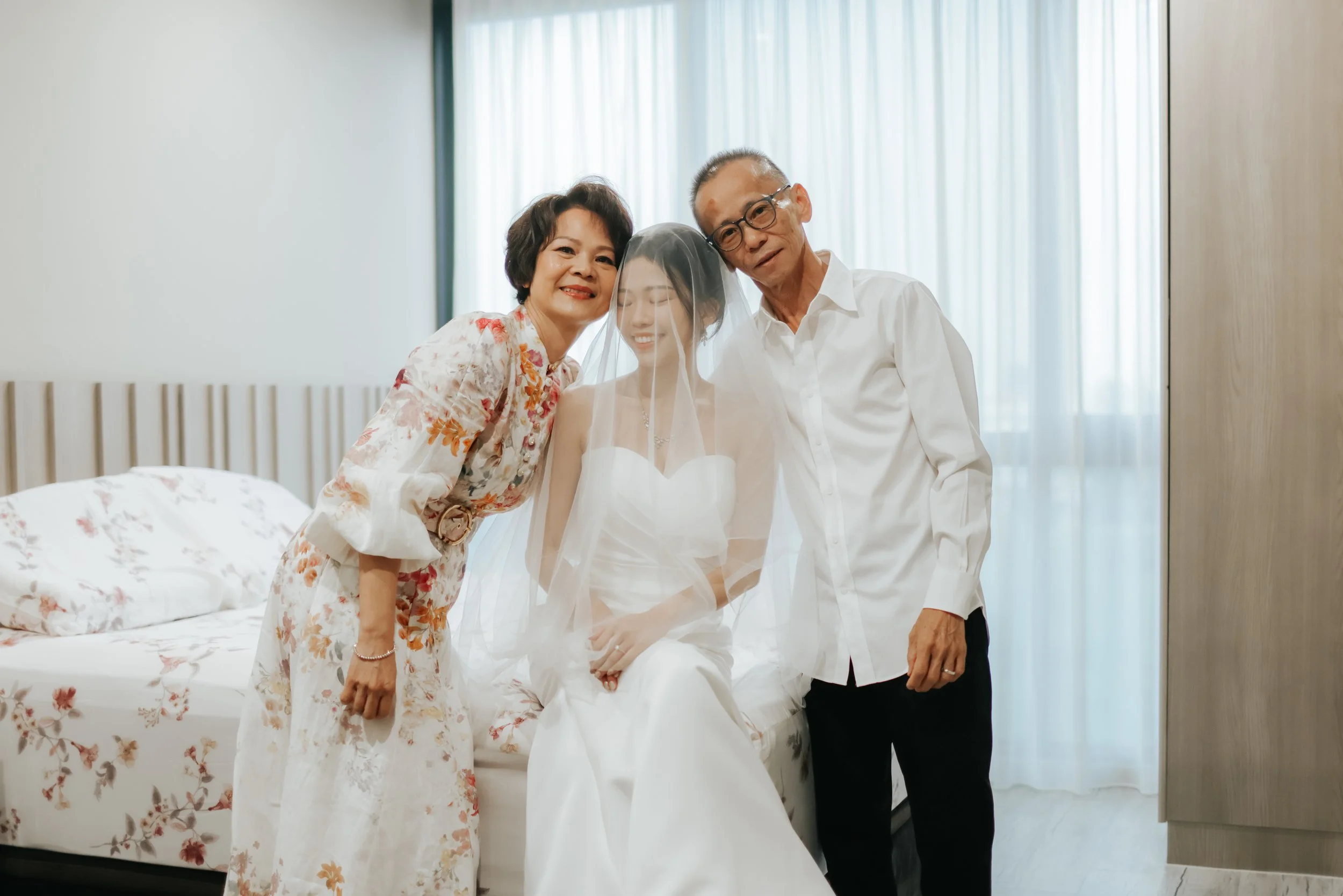 Light and airy actual day wedding photoshoot at the bride's home just after her parents have veiled her. Captured by Arielle for Breadandbutterworks.