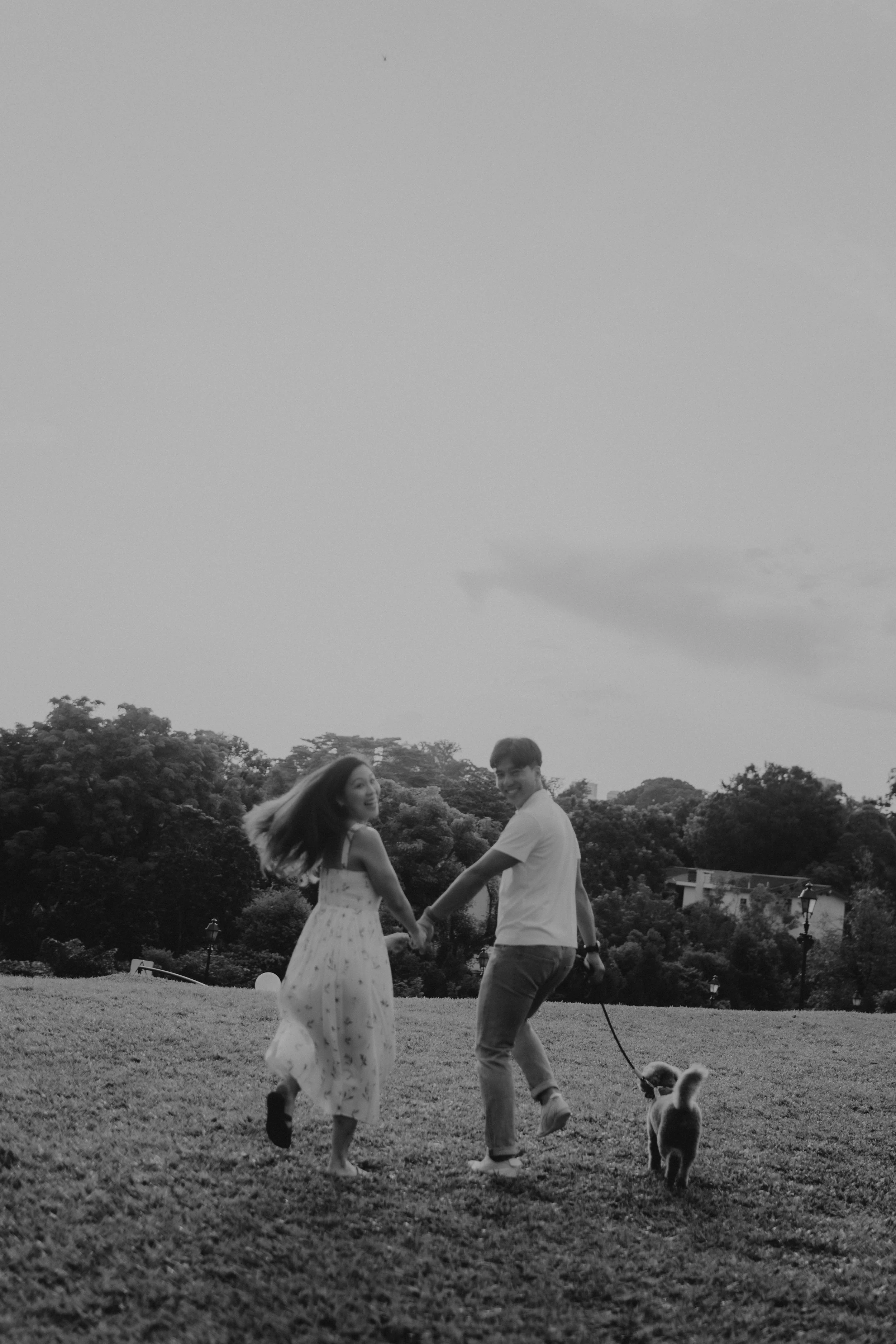 Light and airy, black and white pre-wedding photoshoot with pet dog at Gallop Extension. Captured by Breadandbutterworks.