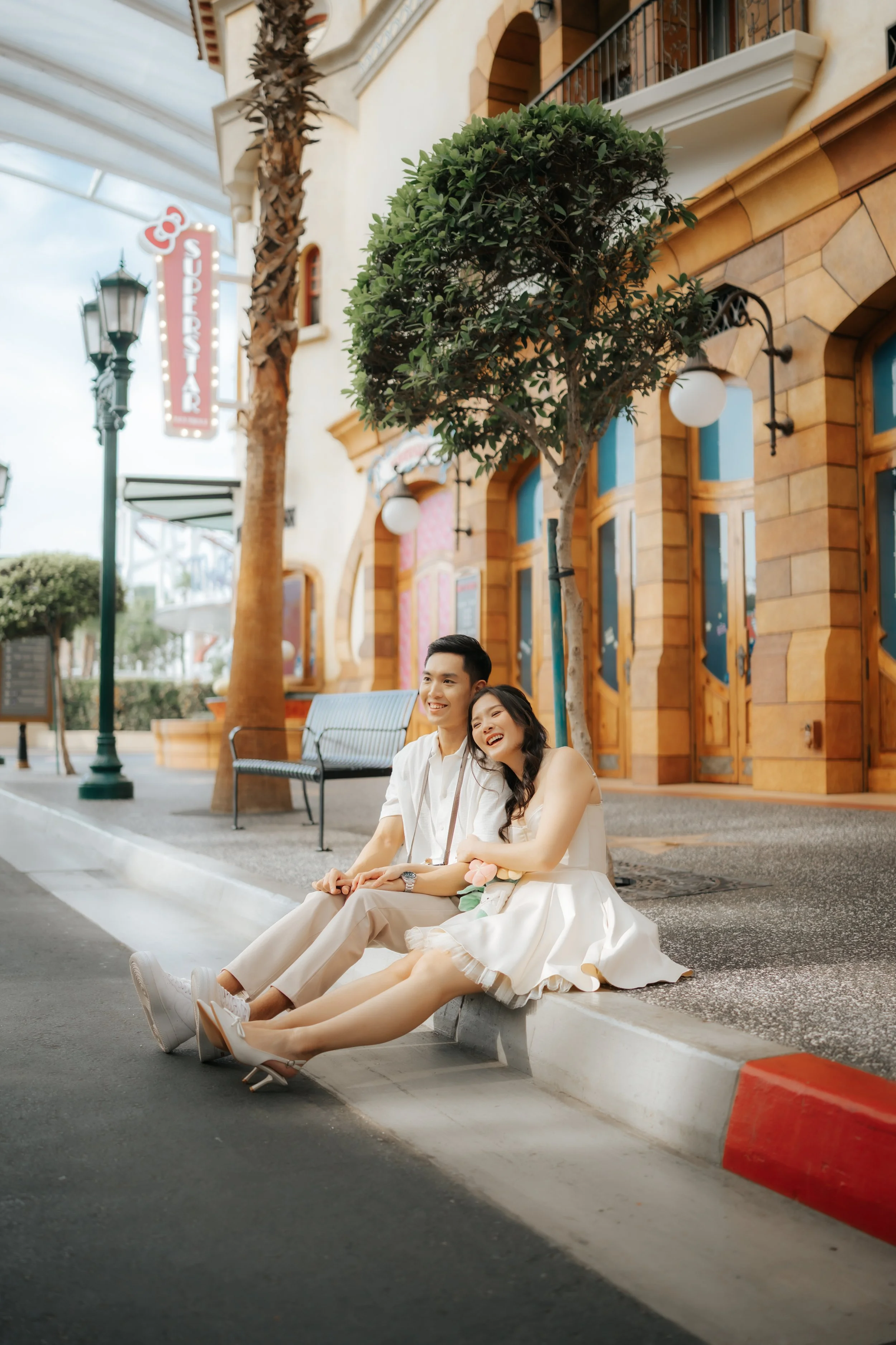 Couple posing for pre-wedding photoshoot in Universal Studios Singapore, captured by Ash for Breadandbutterworks.