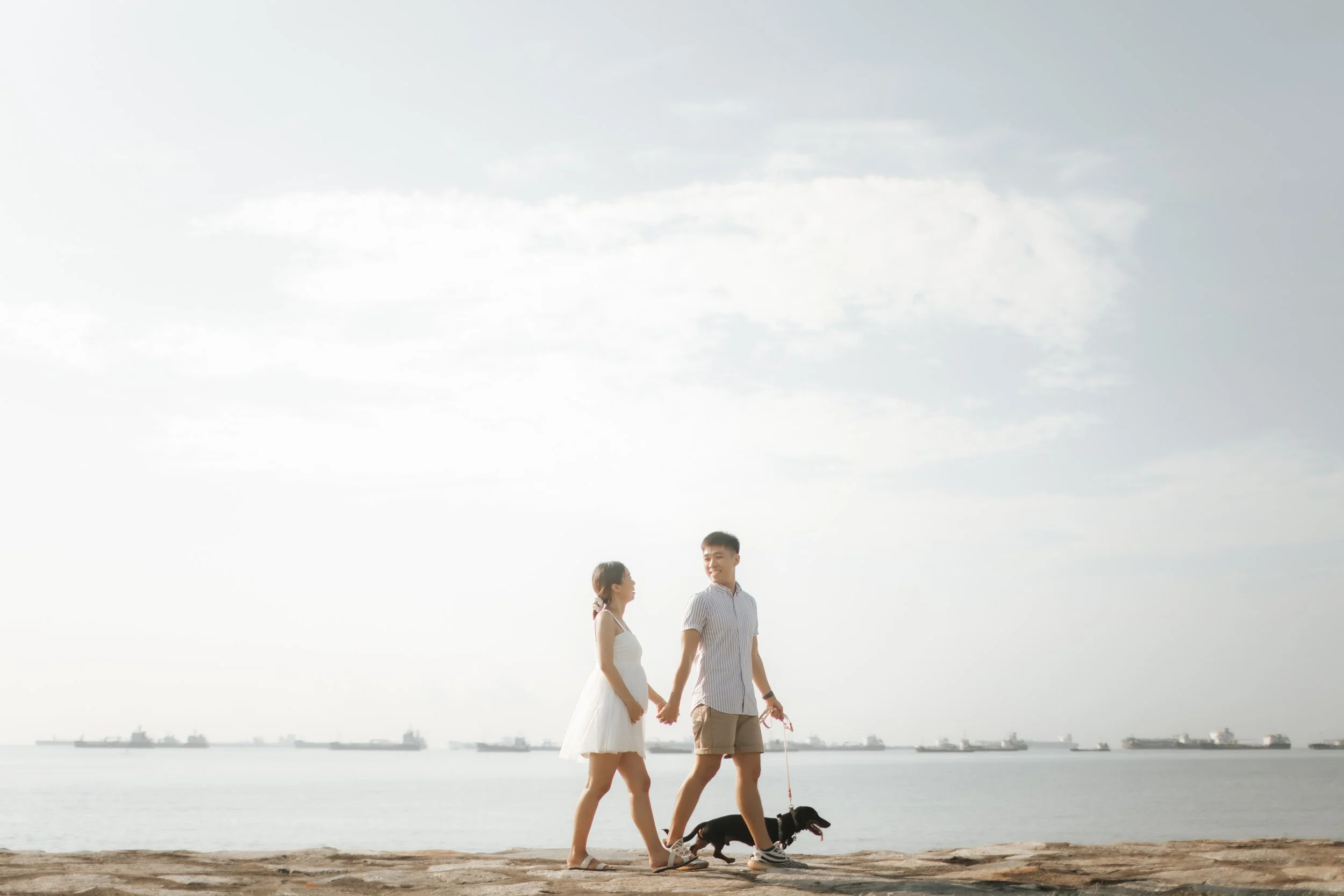 Light and airy maternity beach photoshoot at East Coast Park with a pet dog, captured by Arielle for Breadandbutterworks.