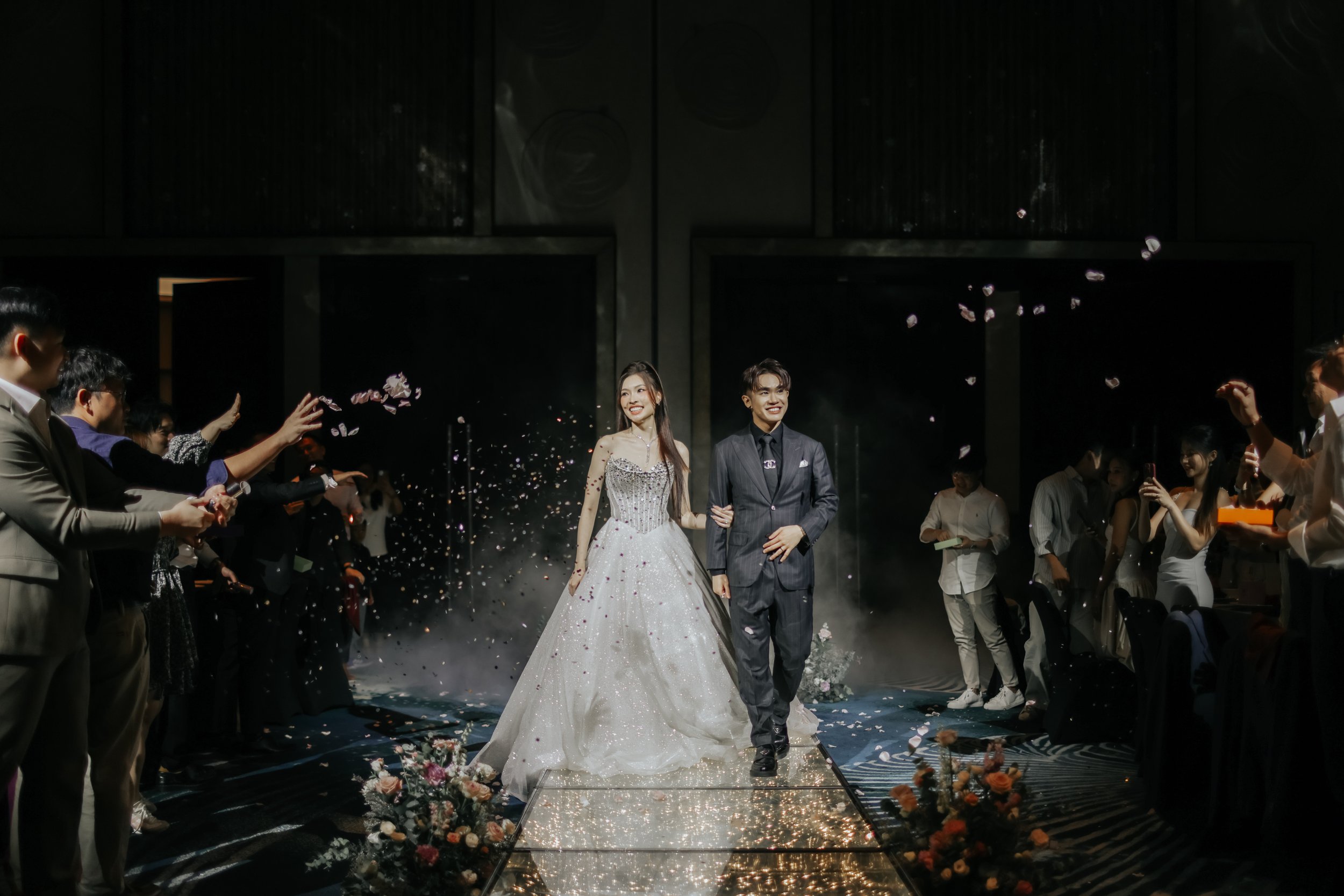 Actual day wedding photoshoot at W Hotel, the bride and groom walks down the aisle at the wedding venue looking stunning in their outfits. Captured by Arielle from Breadandbutterworks.