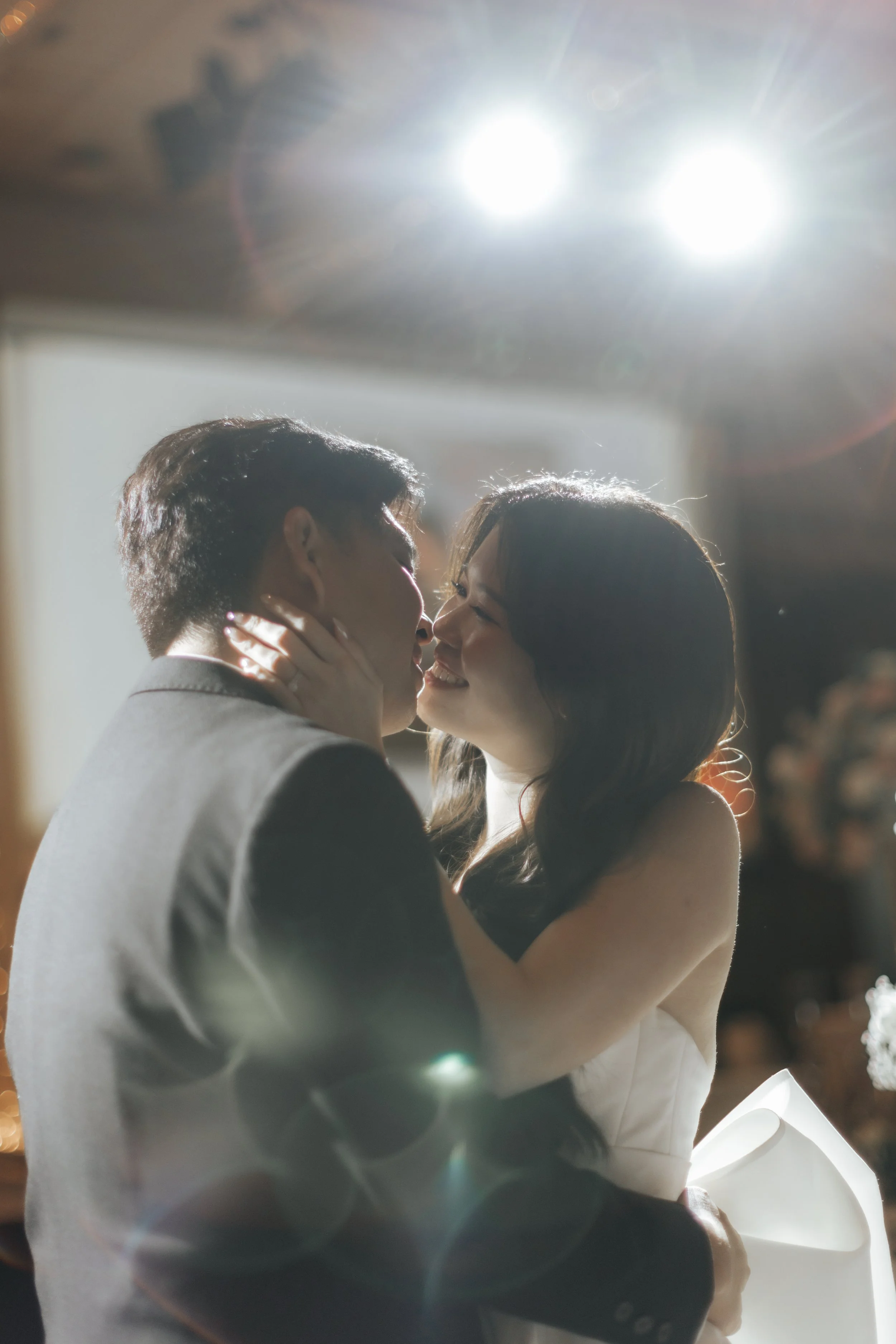 Romantic actual day wedding photo of the bride and groom sharing their wedding kiss, captured by Breadandbutterworks in a soft and heartfelt style.