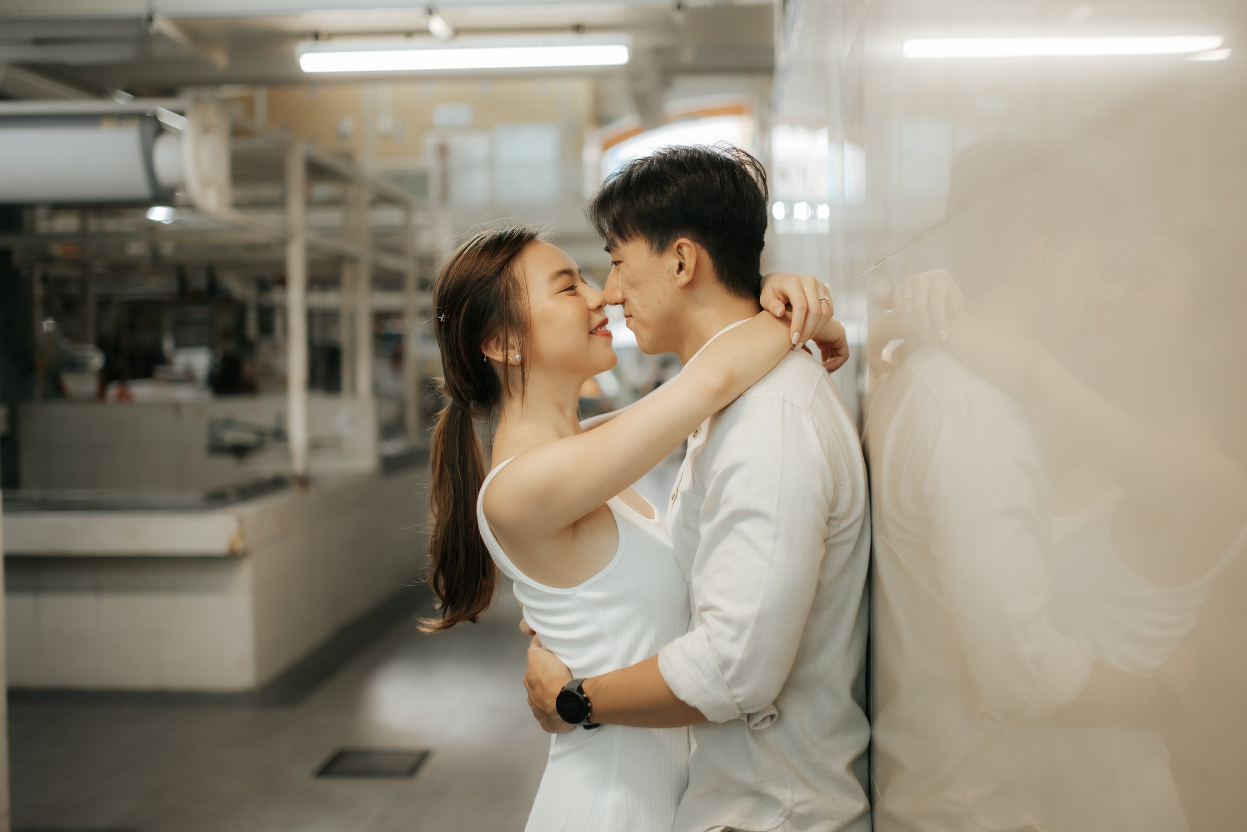 Light and airy pre-wedding photoshoot in the heartlands of Singapore, featuring a hawker centre. Captured by Ash for Breadandbutterworks.