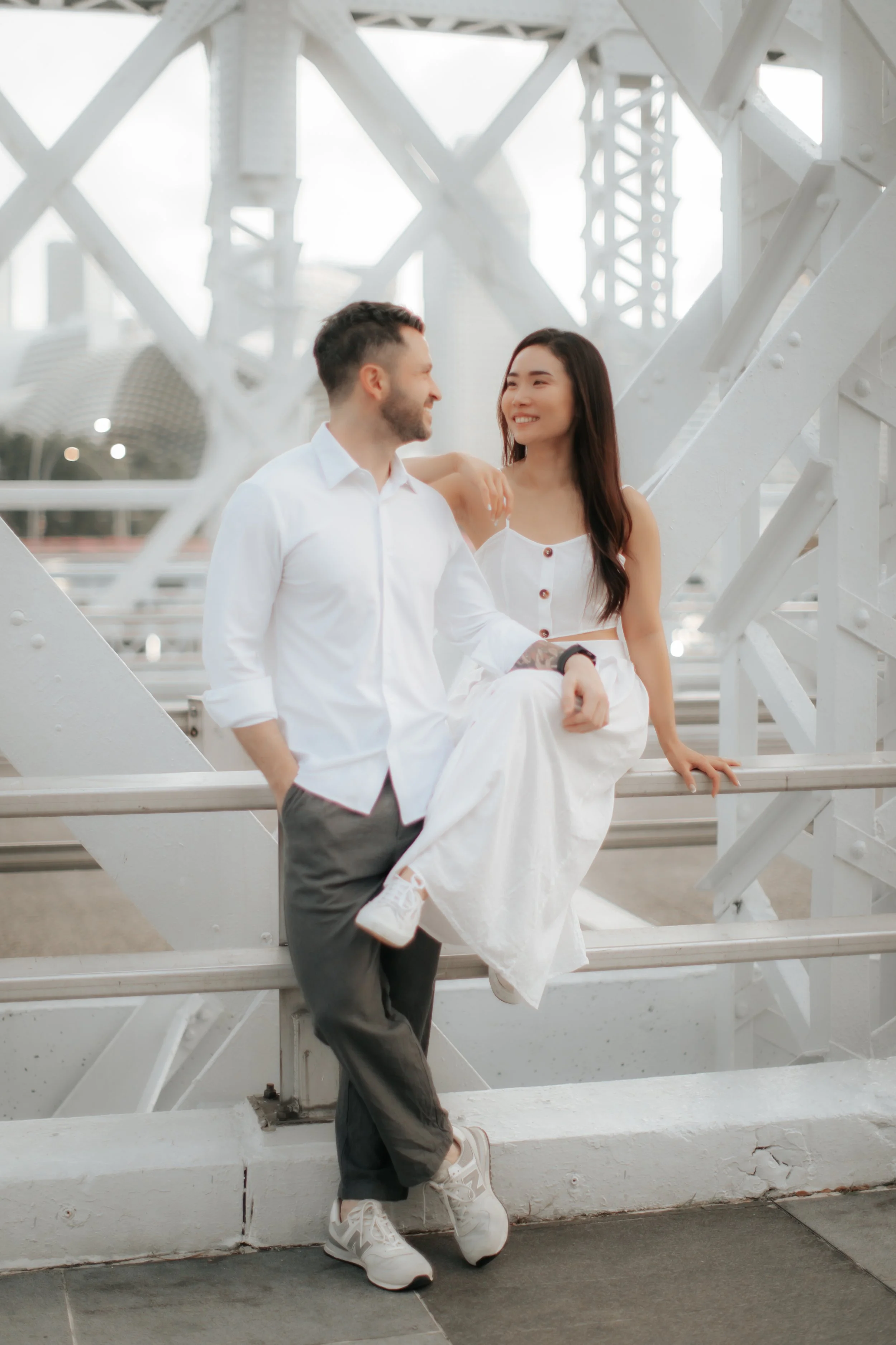 Light and airy proposal photoshoot at Anderson Bridge, the couple poses on the bridge. Captured by Arielle for Breadandbutterworks.