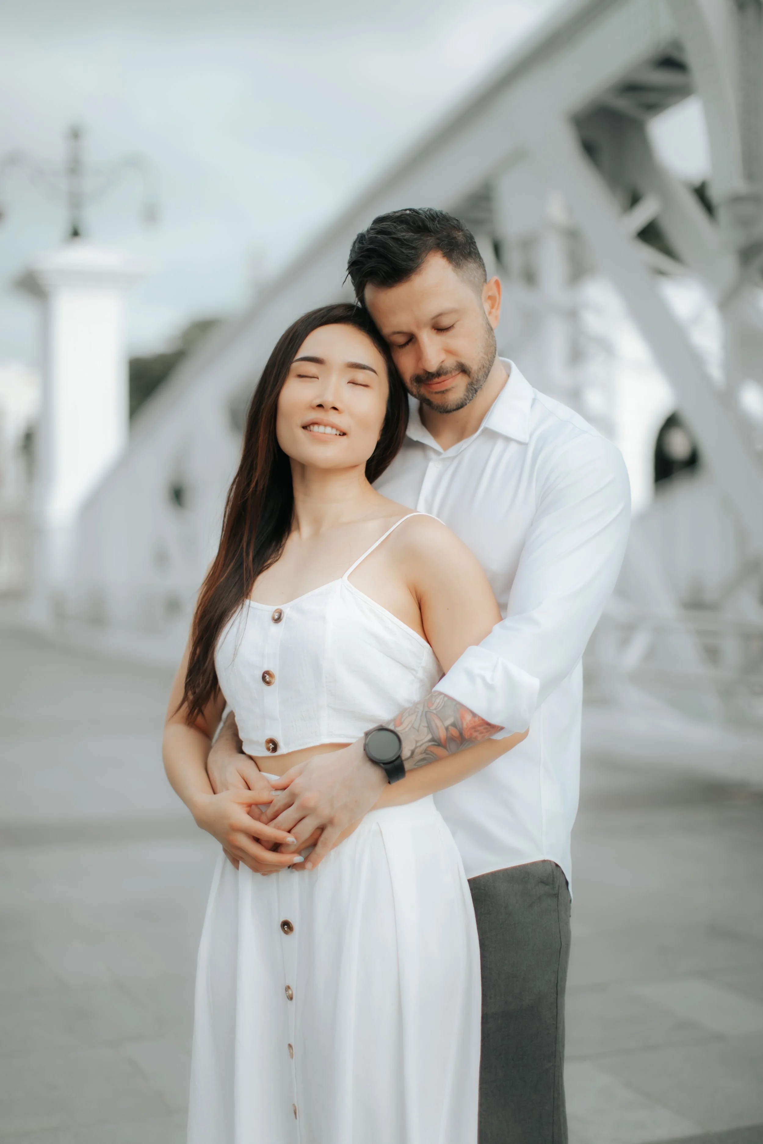 Light and airy proposal photoshoot at Anderson Bridge, the couple poses on the bridge. Captured by Arielle for Breadandbutterworks.