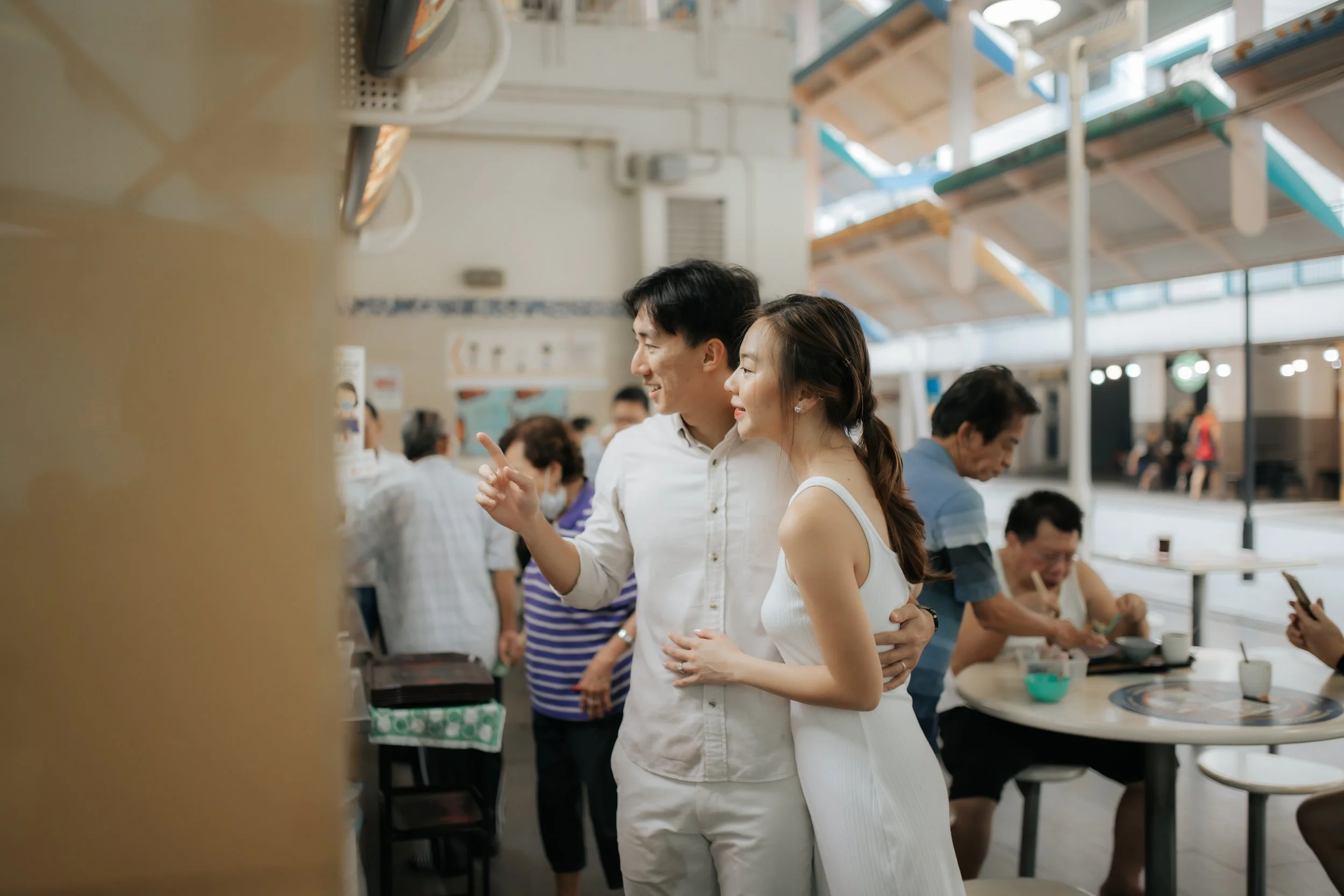 Light and airy pre-wedding photoshoot in the heartlands of Singapore, featuring a hawker centre. Captured by Ash for Breadandbutterworks.