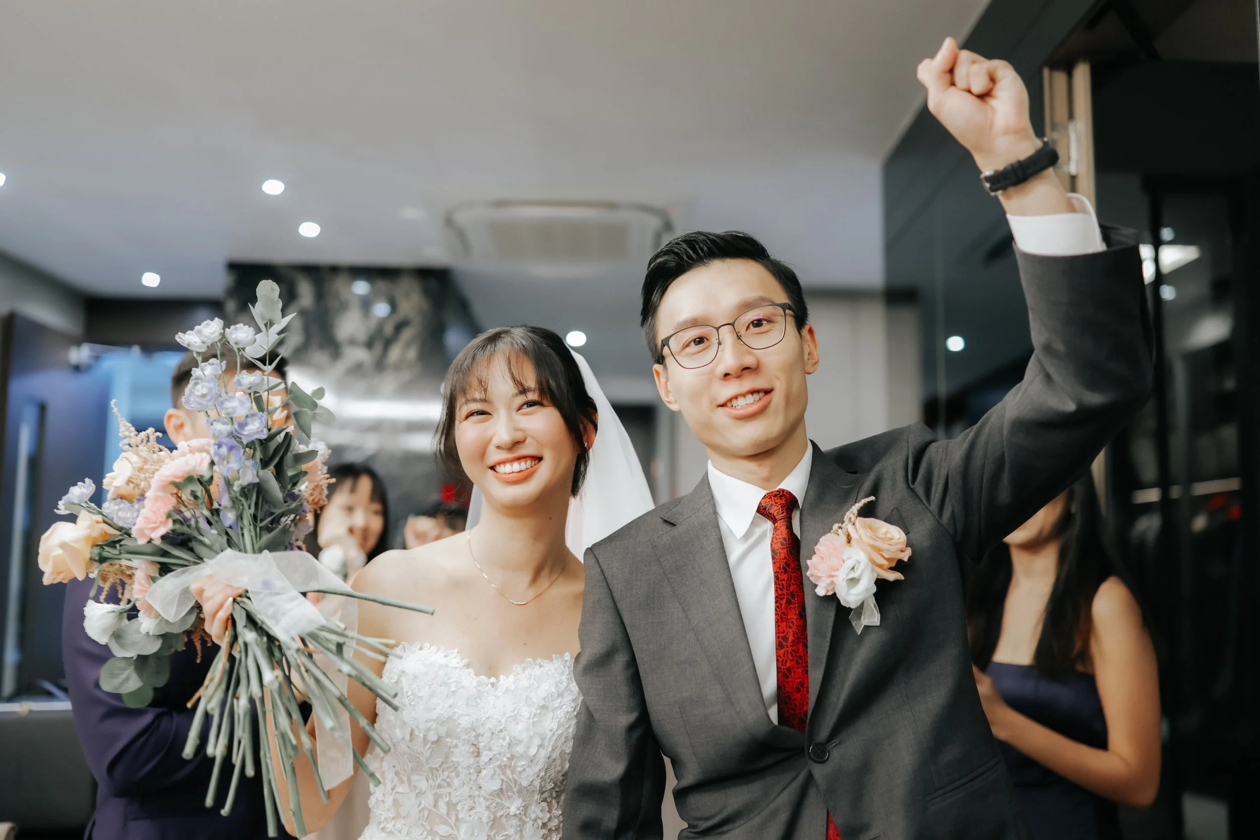 Cheerful actual day wedding photograph of a couple as their walk among their guests amid cheers and love. Photographed by Breadandbutterworks.
