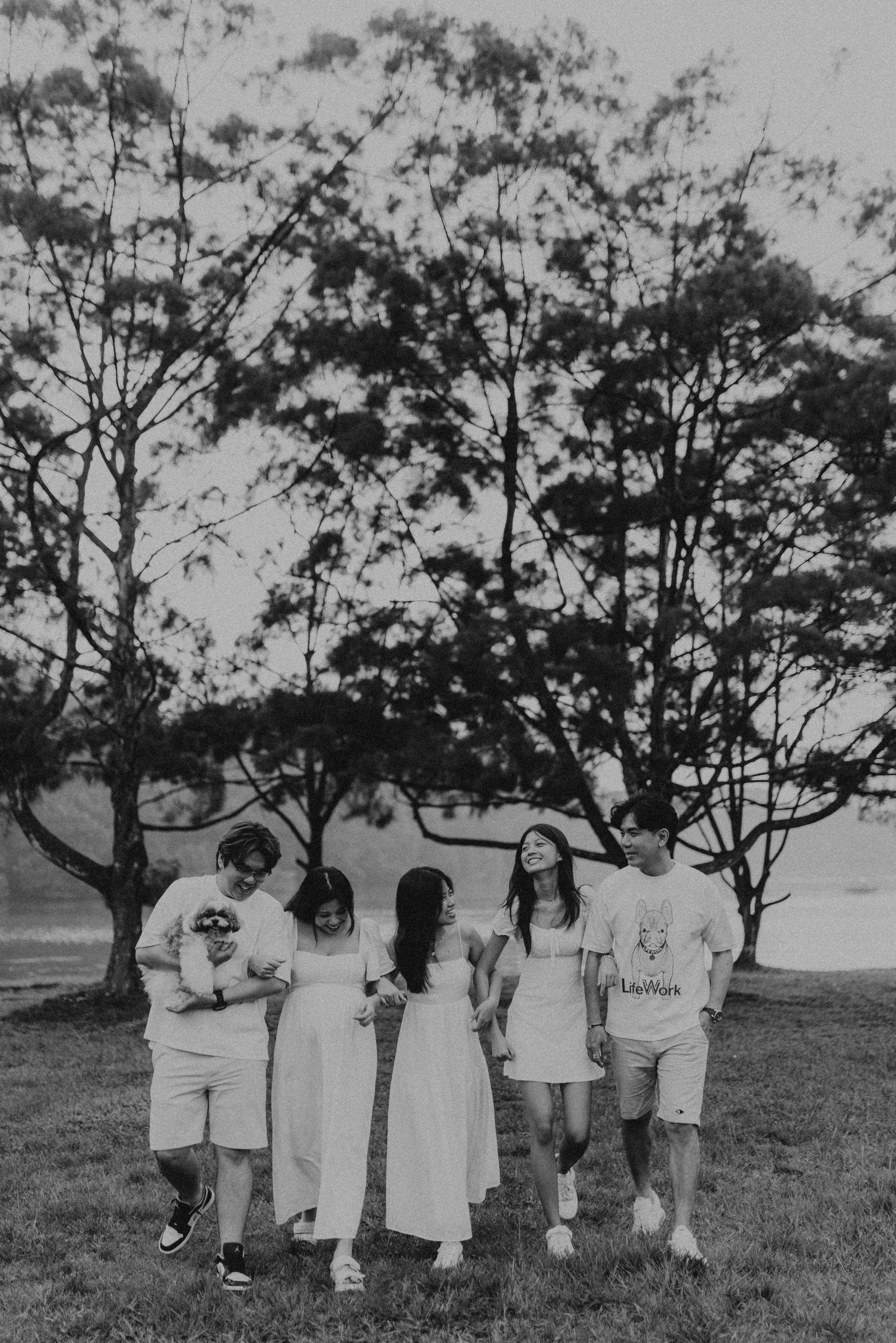 Black and white cinematic family photoshoot with the family dog, taken at Upper Peirce Reservoir. Captured by Breadandbutterworks in a light and airy style.