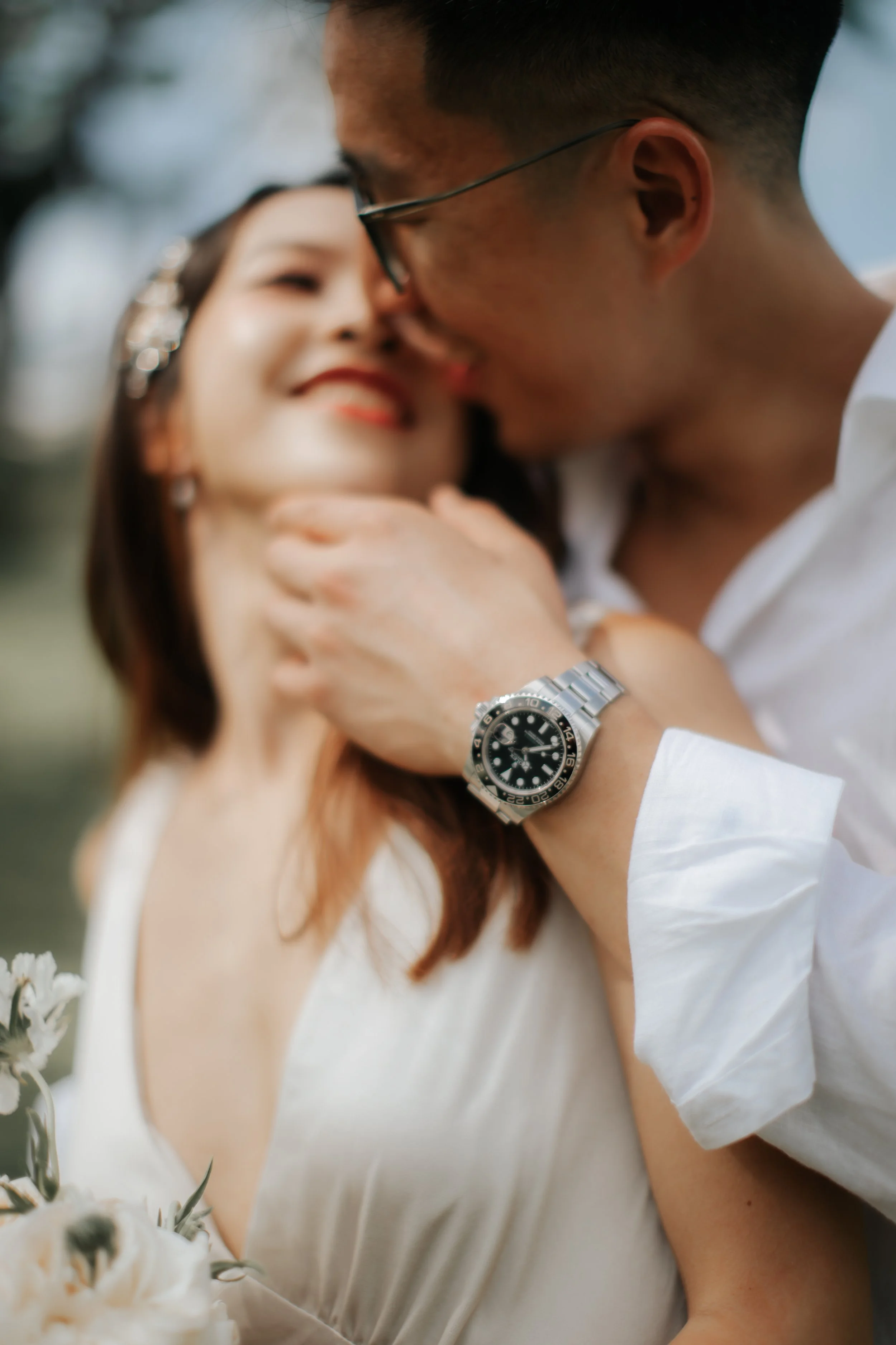 Light and airy pre-wedding photoshoot at Arwaa Mansion, featuring an artistic close-up and bokeh effect on the couple's accessory details. Captured by Ash for Breadandbutterworks.