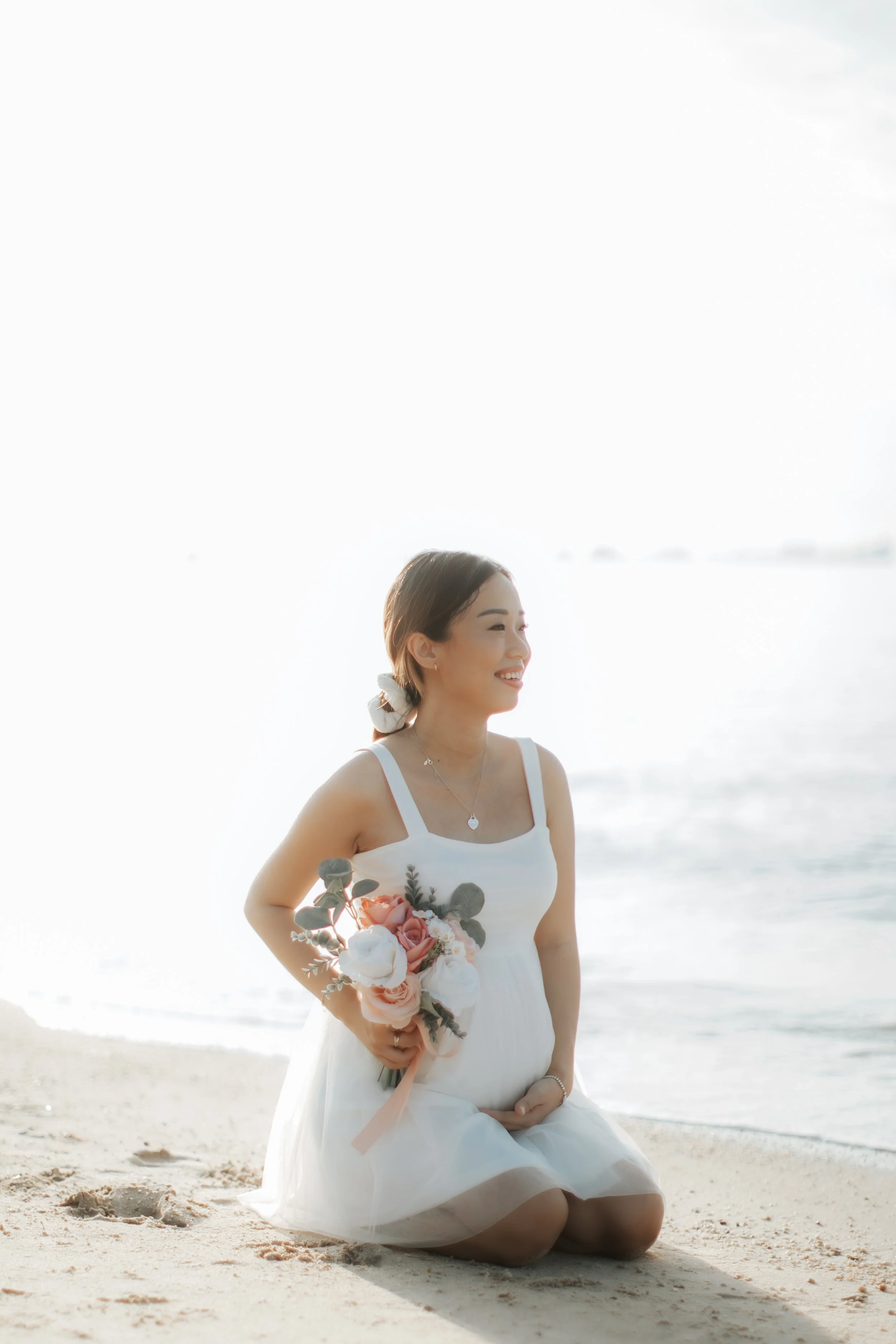 Light and airy maternity beach photoshoot at East Coast Park with a pet dog, captured by Arielle for Breadandbutterworks.