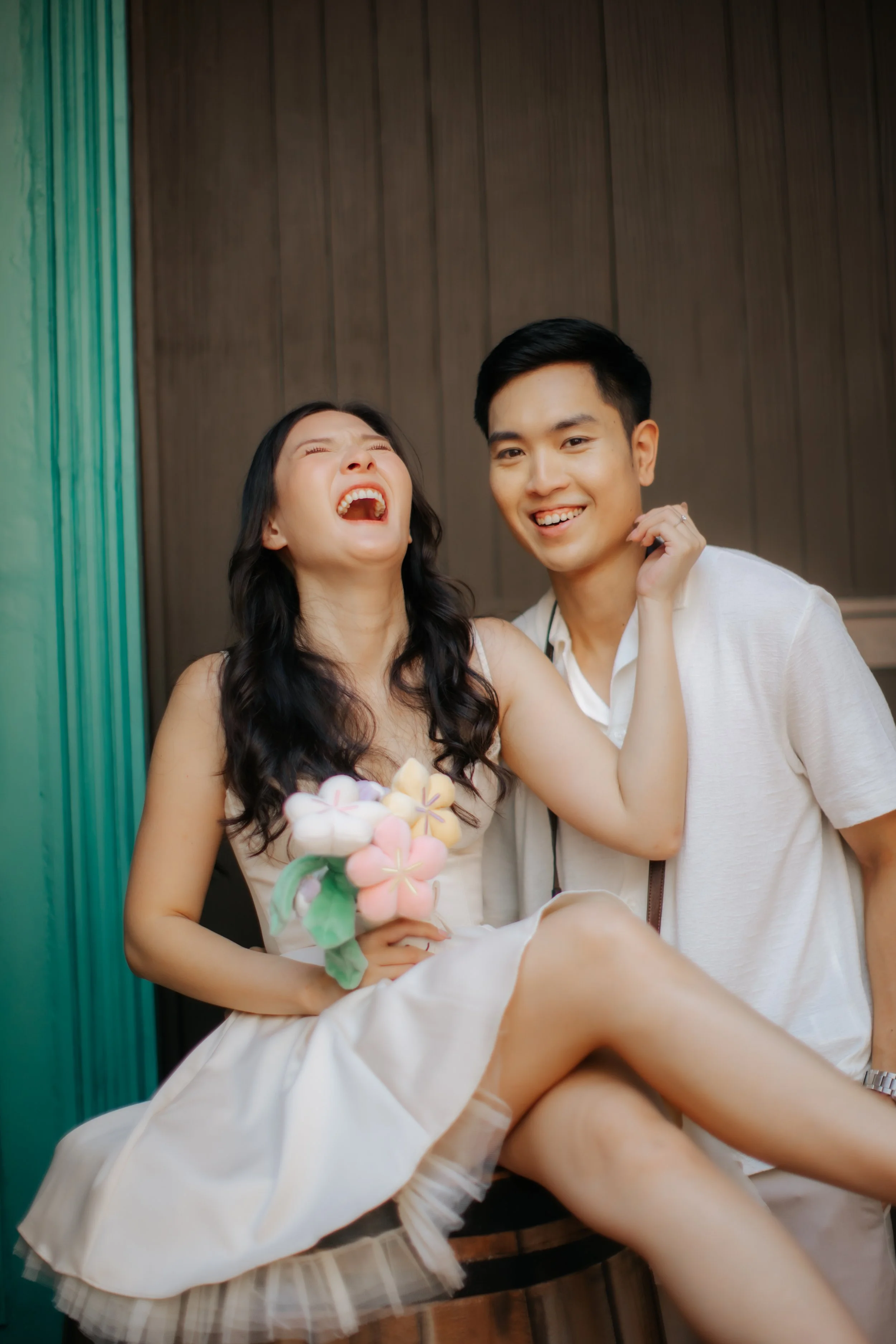 Couple posing for pre-wedding photoshoot in Universal Studios Singapore, captured by Ash for Breadandbutterworks.