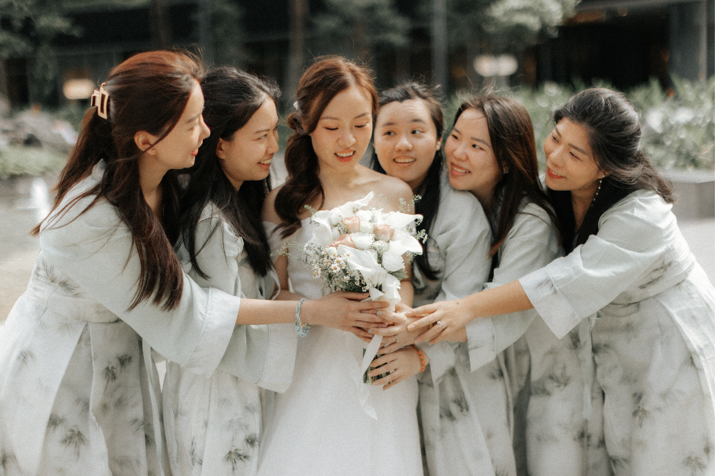 Joyful actual day wedding photoshoot of the bride and her bridesmaids, captured by Breadandbutterworks in a soft and heartfelt style.