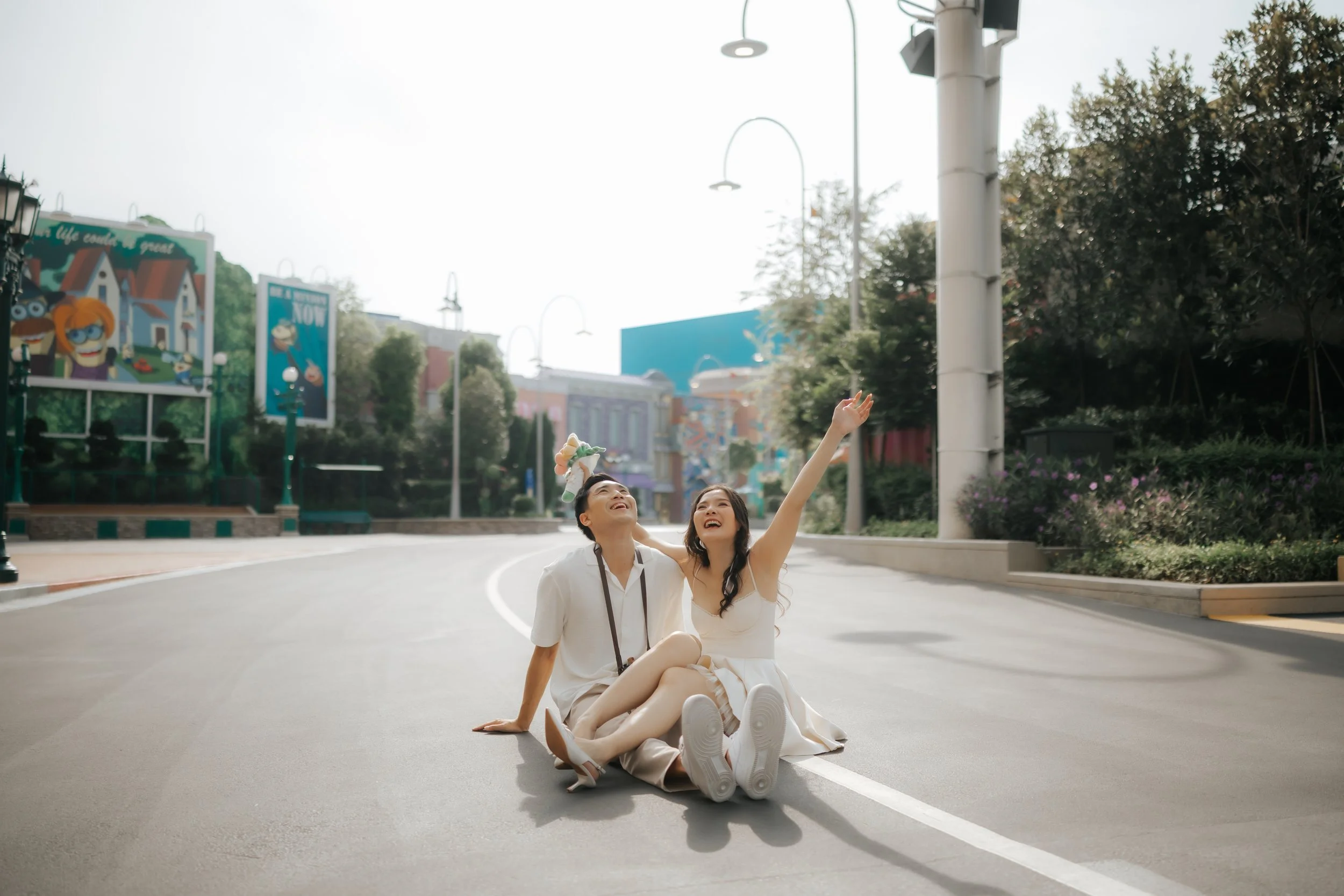Couple posing for pre-wedding photoshoot in Universal Studios Singapore, captured by Ash for Breadandbutterworks.