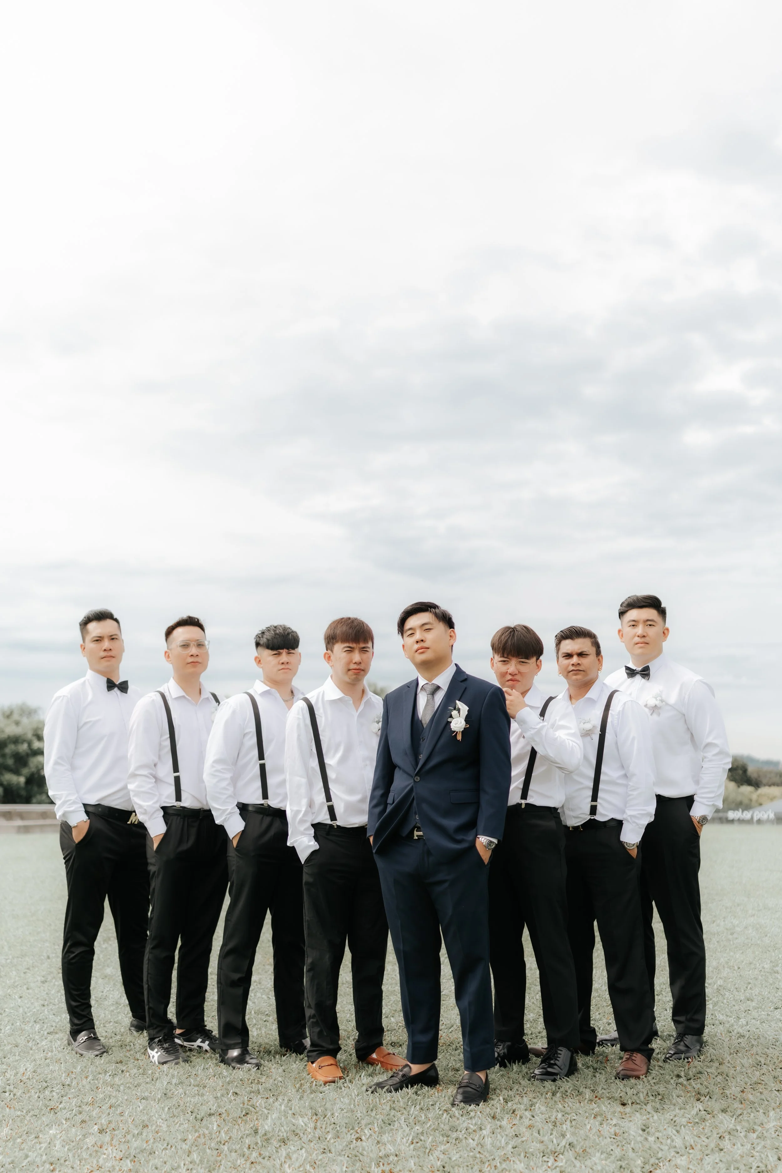 Charming actual day wedding photo of the groom and his groomsmen, this was captured along Marina Barrage by Breadandbutterworks in a soft and heartfelt style.