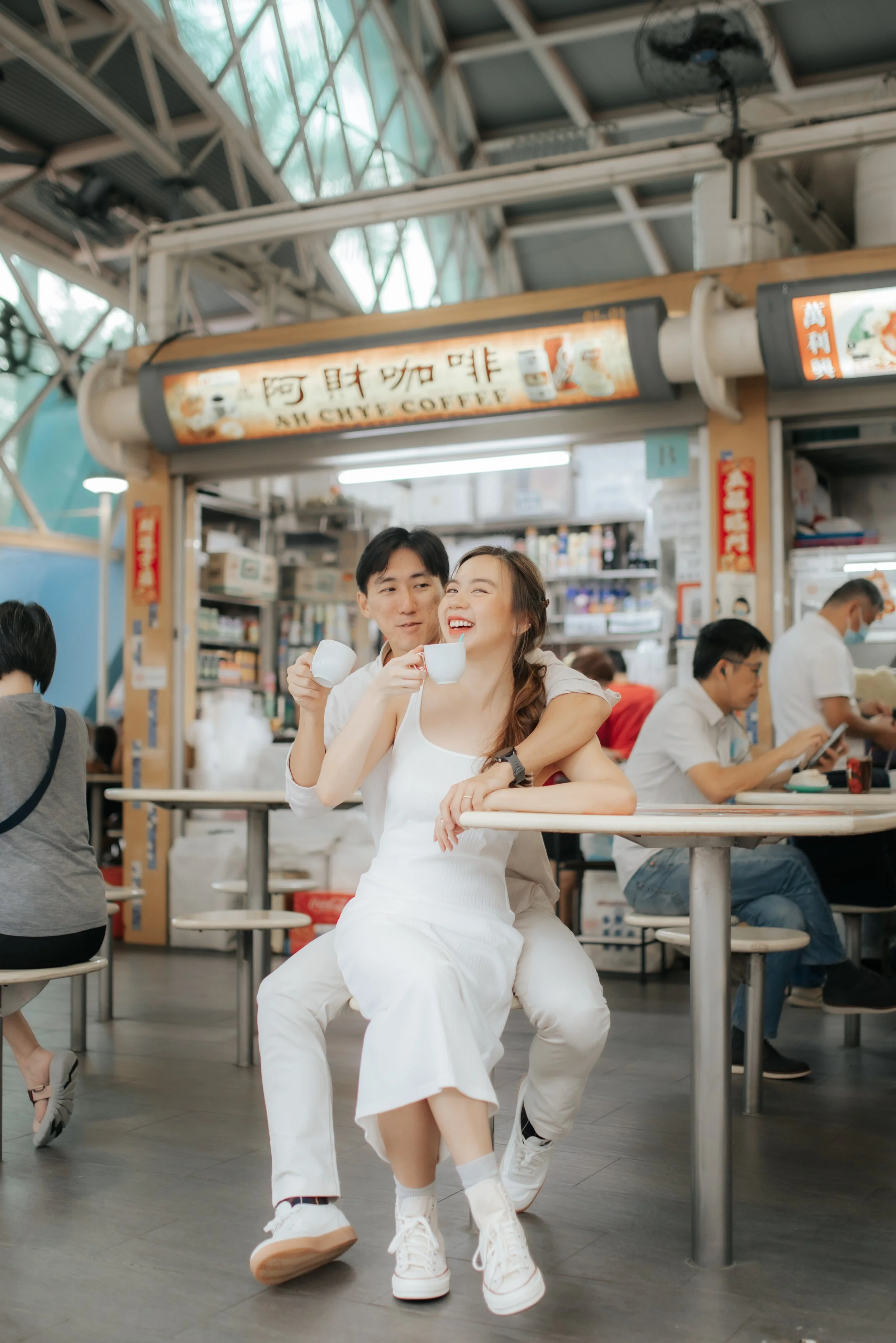 Light and airy pre-wedding photoshoot in the heartlands of Singapore, featuring a hawker centre. Captured by Ash for Breadandbutterworks.