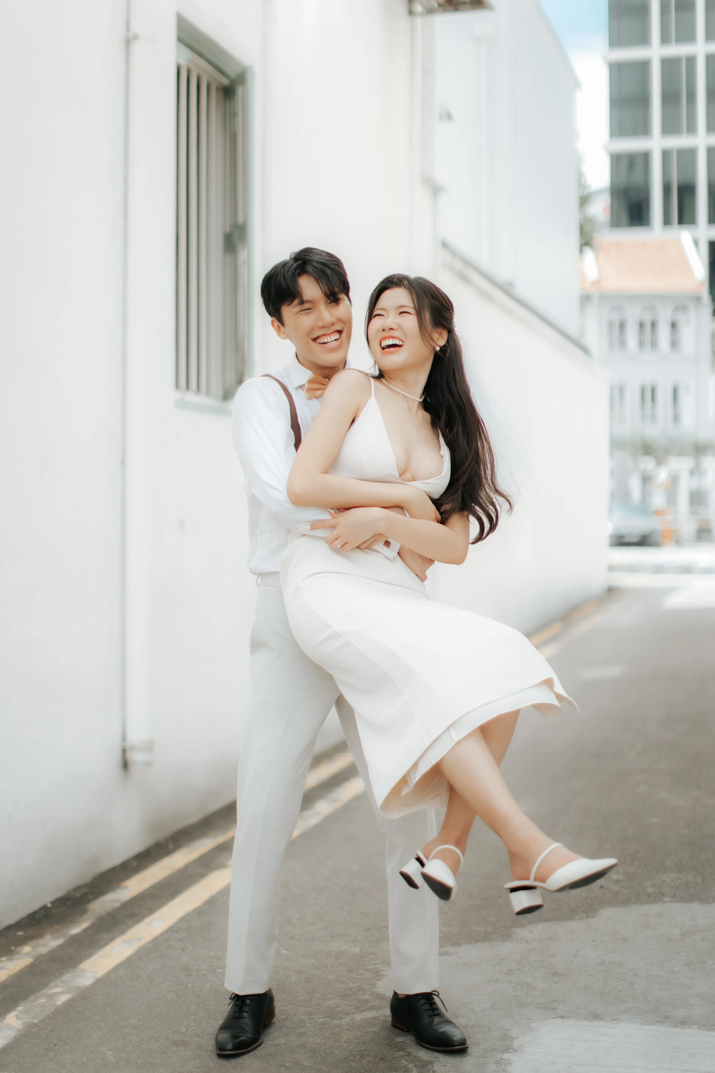 Light and airy pre-wedding photoshoot of a cheerful colour at Keong Siak Street in Singapore, captured by Arielle for Breadandbutterworks.