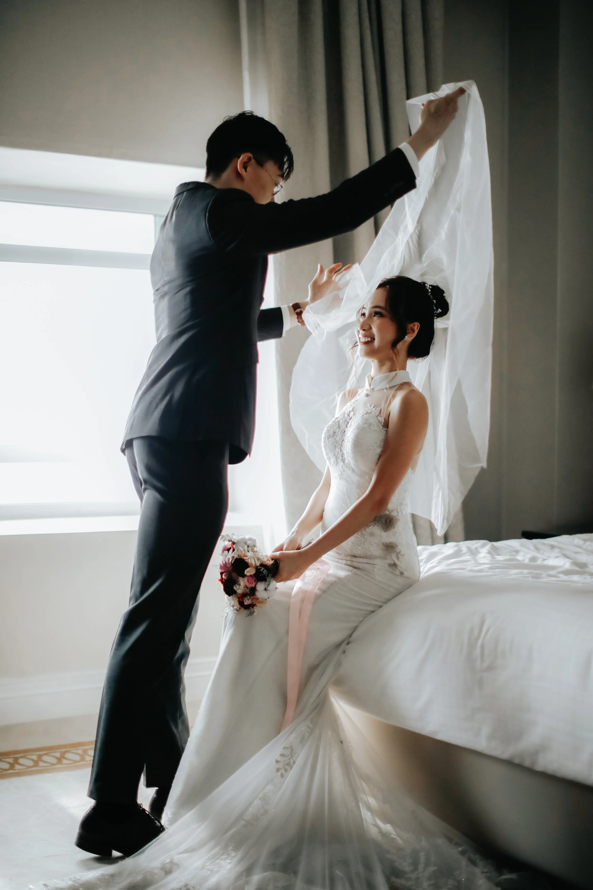 Light and airy actual day wedding photoshoot of the groom's first look at the bride-to-be as he unveils her. Captured by Arielle for Breadandbutterworks.