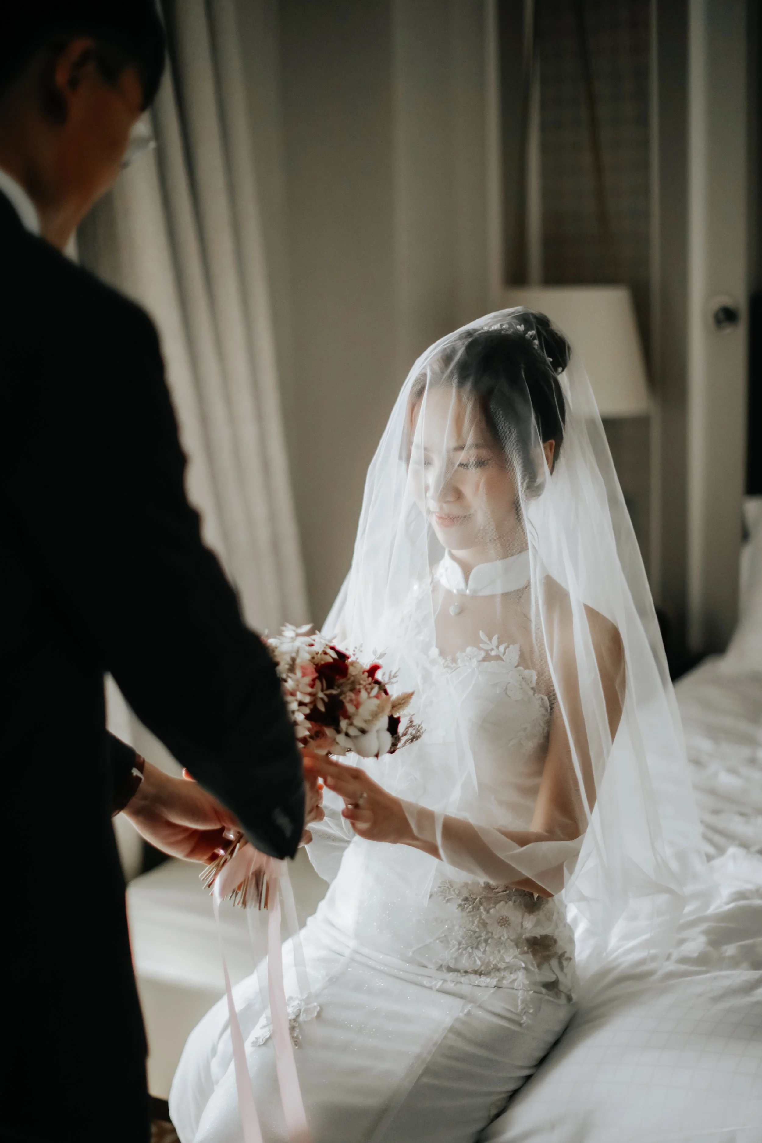 Light and airy actual day wedding photoshoot of the bride-to-be receiving her wedding bouquet from her groom. Captured by Arielle for Breadandbutterworks.