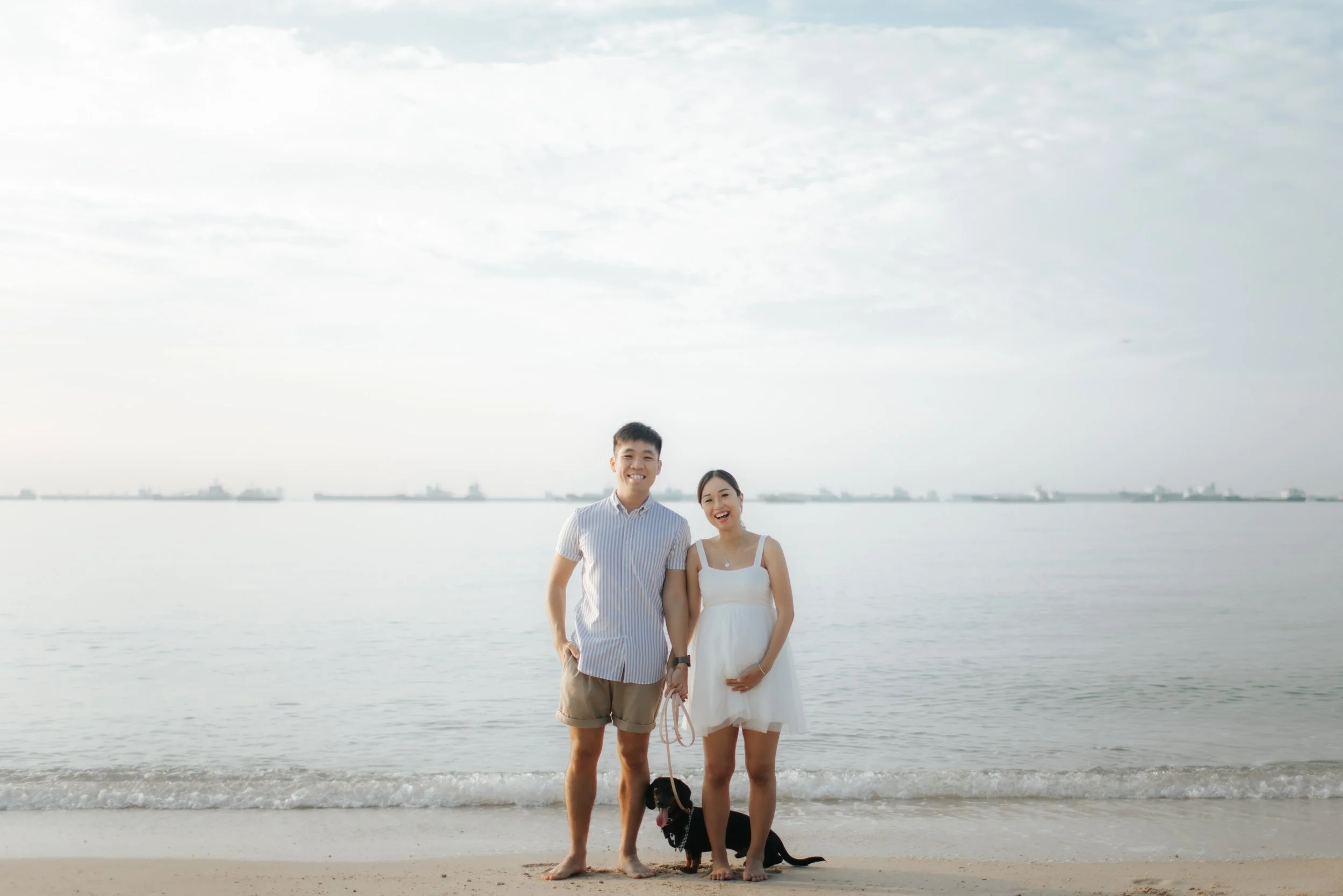 Light and airy maternity beach photoshoot at East Coast Park with a pet dog, captured by Arielle for Breadandbutterworks.