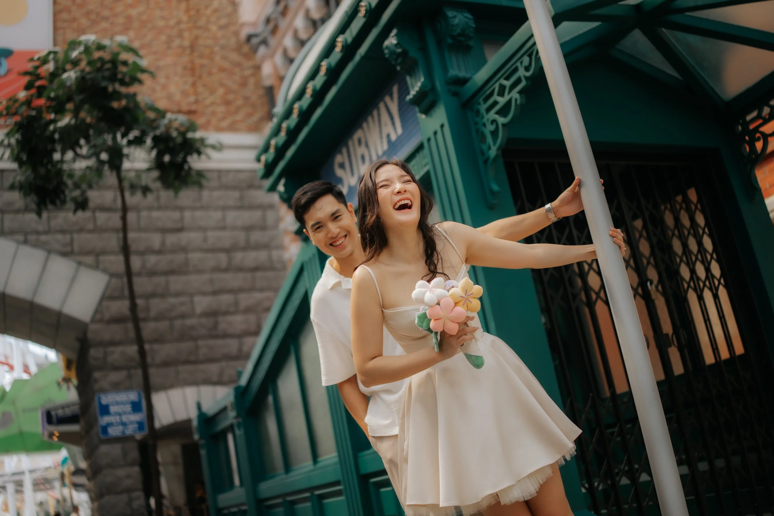 Couple posing for pre-wedding photoshoot in Universal Studios Singapore, captured by Ash for Breadandbutterworks.