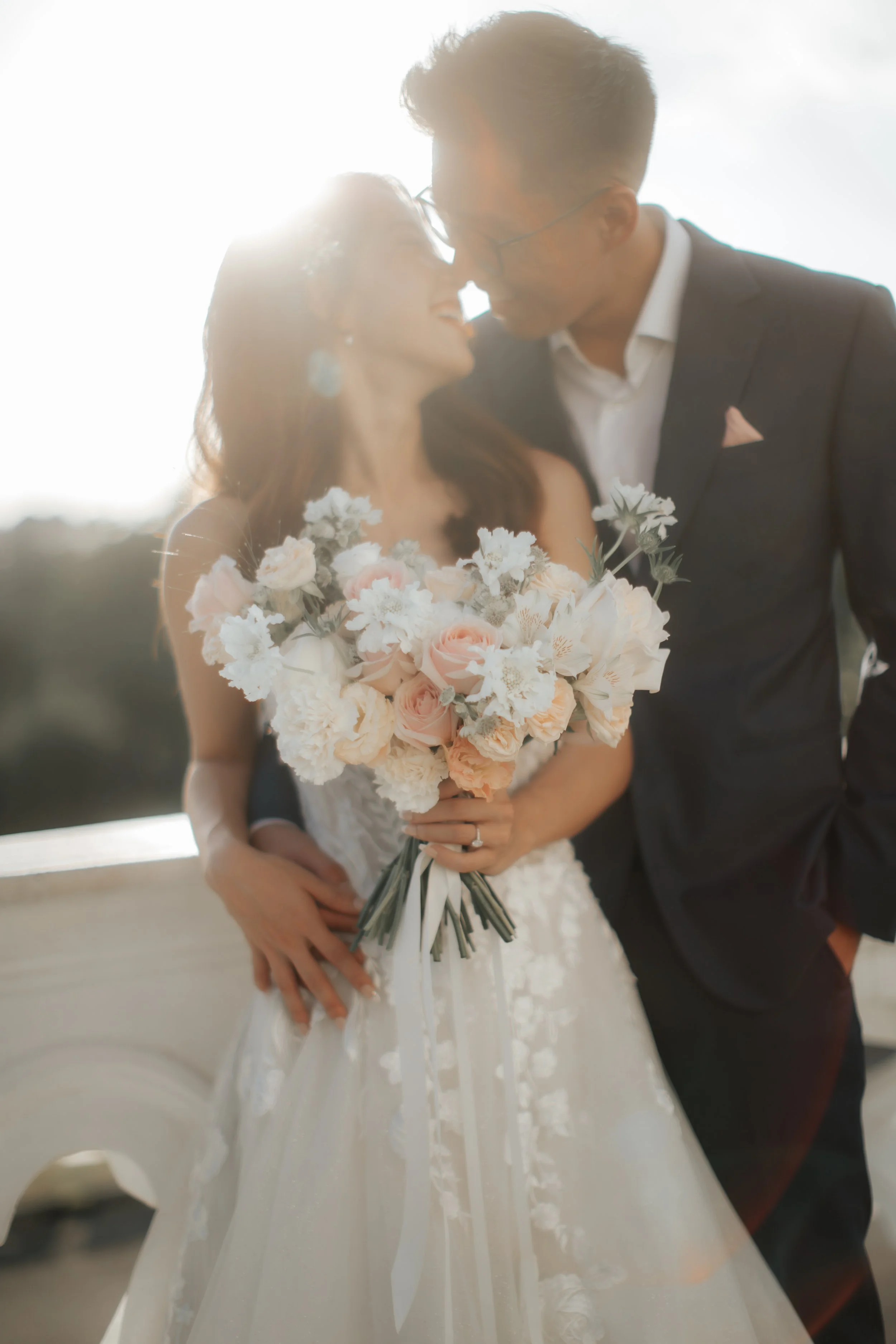 Light and airy pre-wedding photoshoot at Arwaa Mansion, featuring an artistic lens flare on the couple and their bouquet within the colonial architecture. Captured by Ash for Breadandbutterworks.