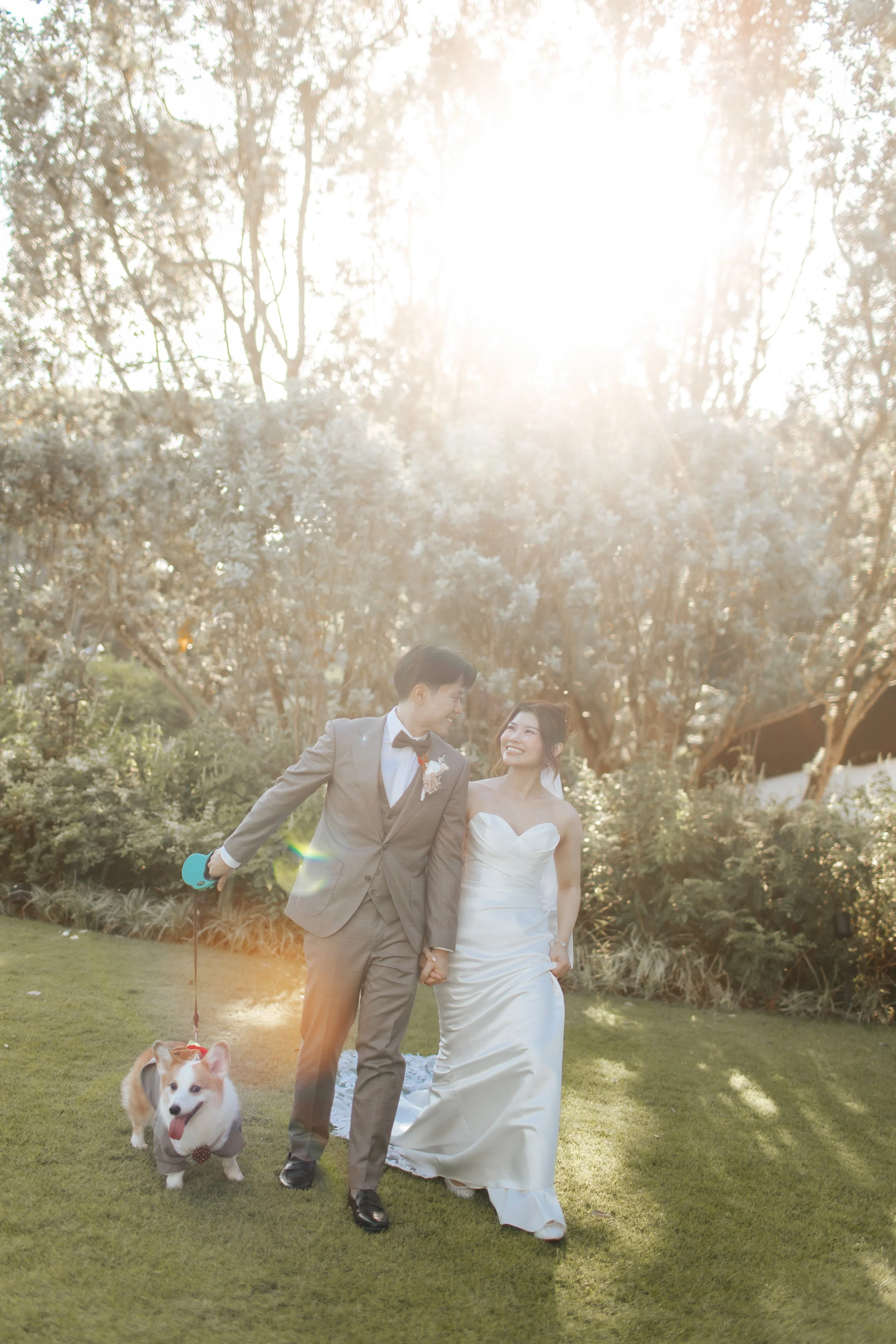 Light and airy actual day wedding photoshoot at Canopy HortPark, the couple poses in a park with their pet dog. Captured by Arielle from Breadandbutterworks.