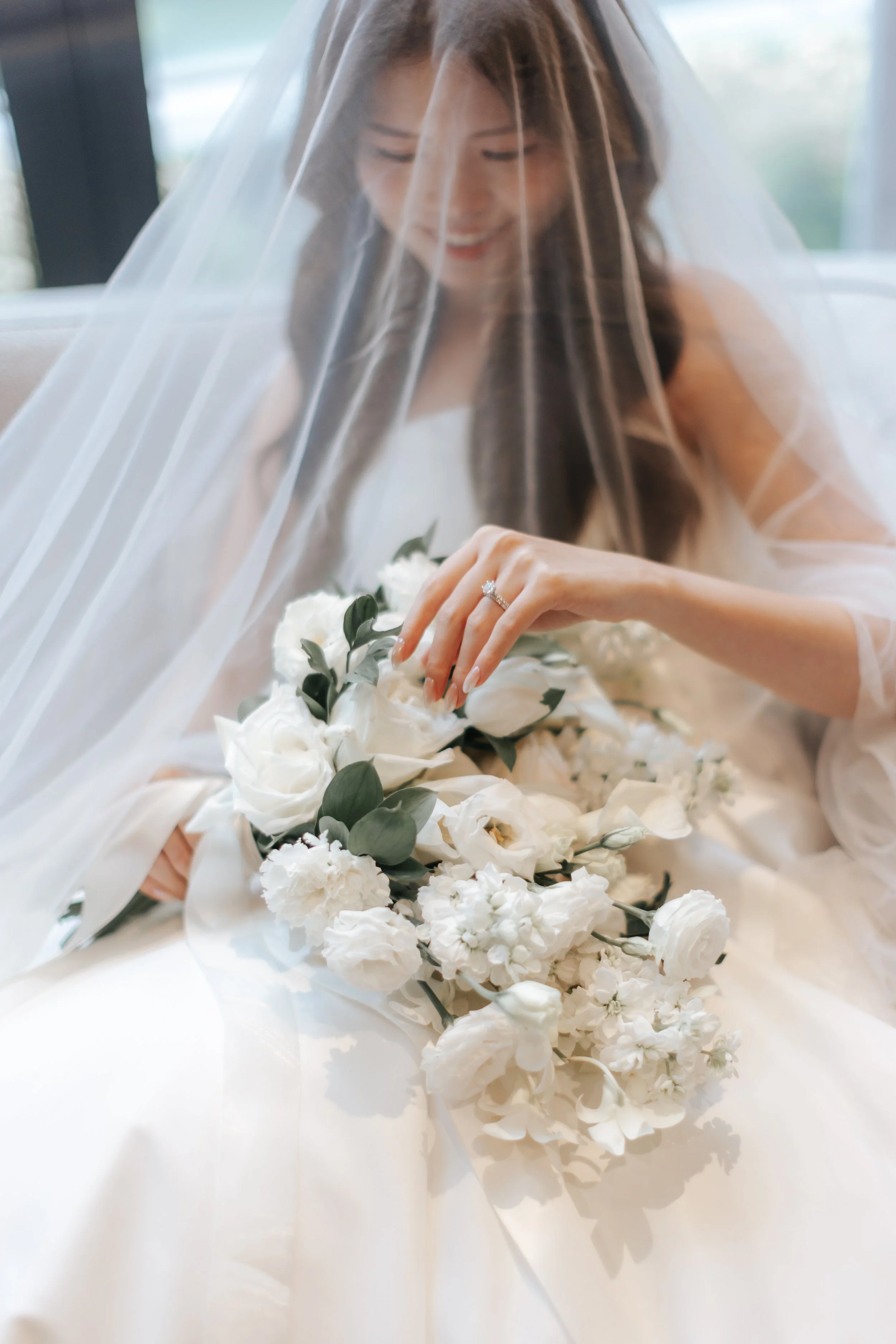 Ethereal actual day bridal photoshoot with her wedding veil and bridal bouquet, captured by Breadandbutterworks in a soft and heartfelt style.