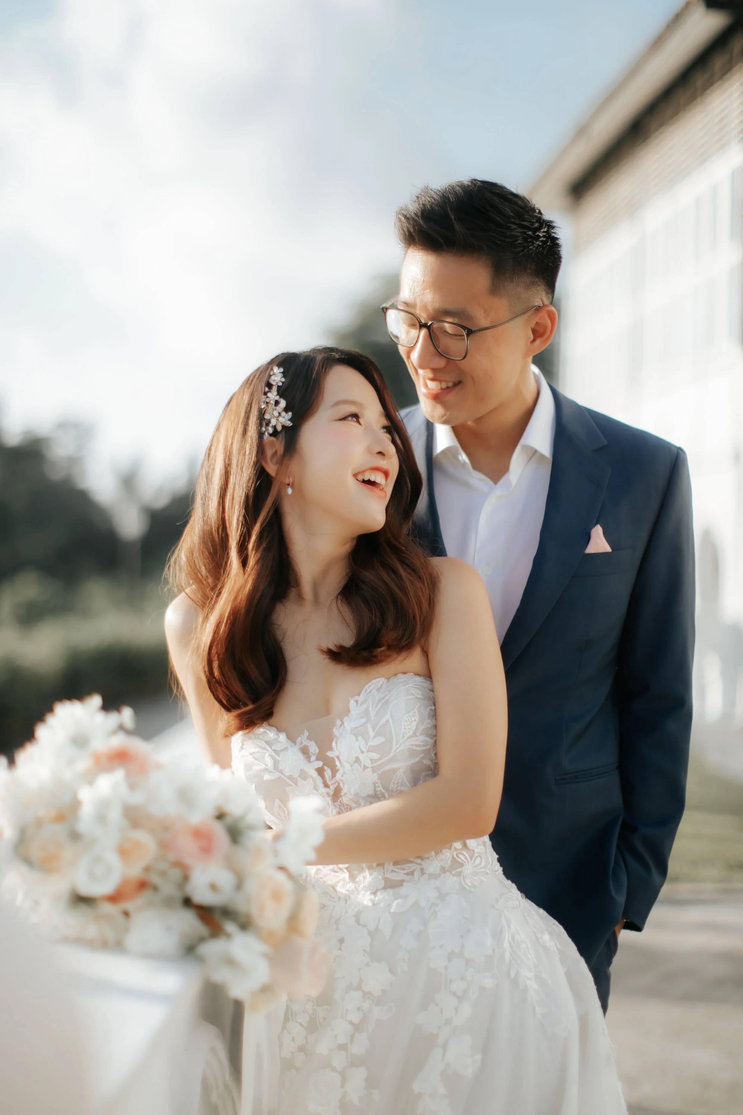 Light and airy pre-wedding photoshoot at Arwaa Mansion, featuring the couple striking a pose with their bouquet with the colonial architecture as the backdrop. Captured by Ash for Breadandbutterworks.