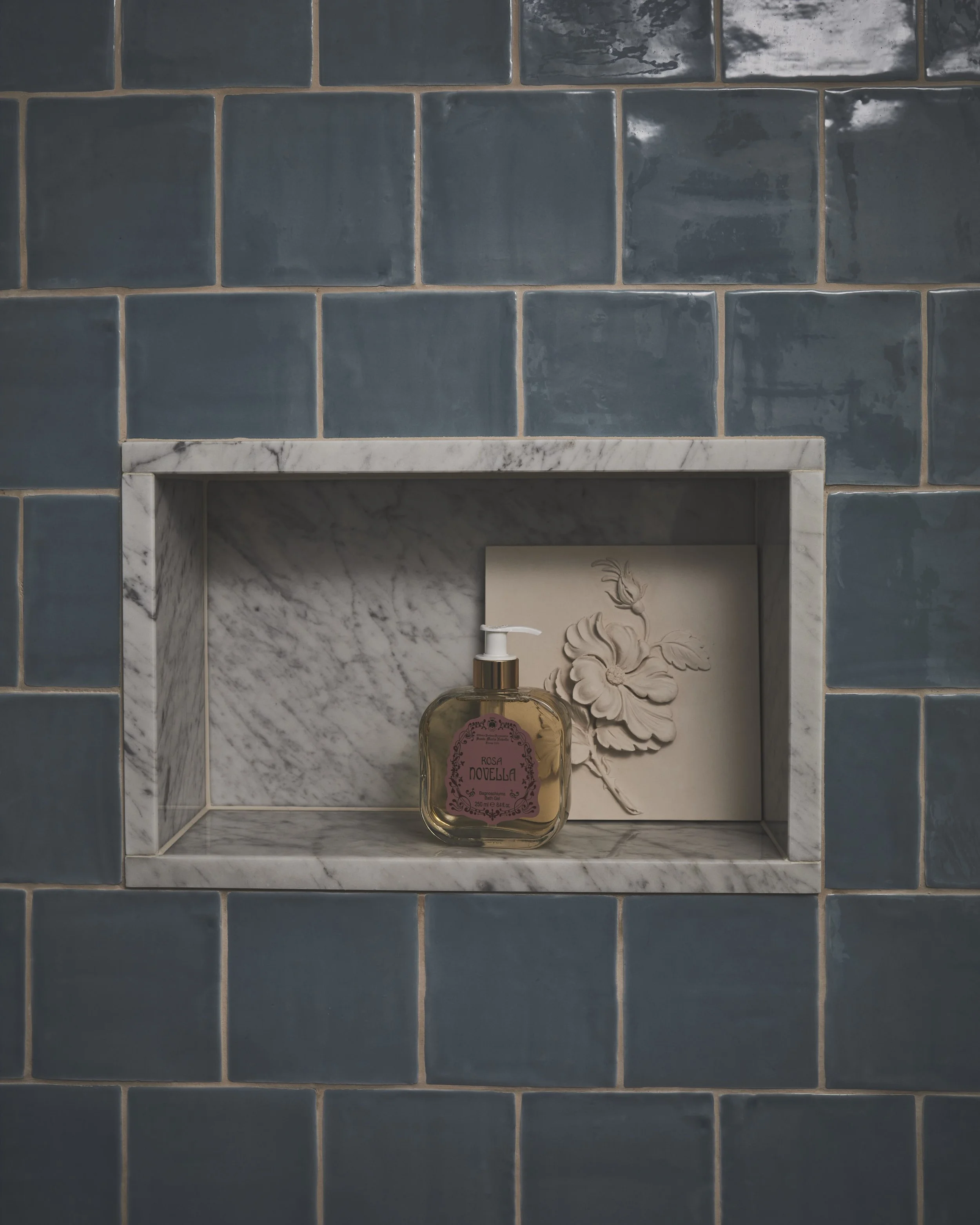 Glazed, glossy, a 'brick' set out, contrasting grout with Carrara marble.