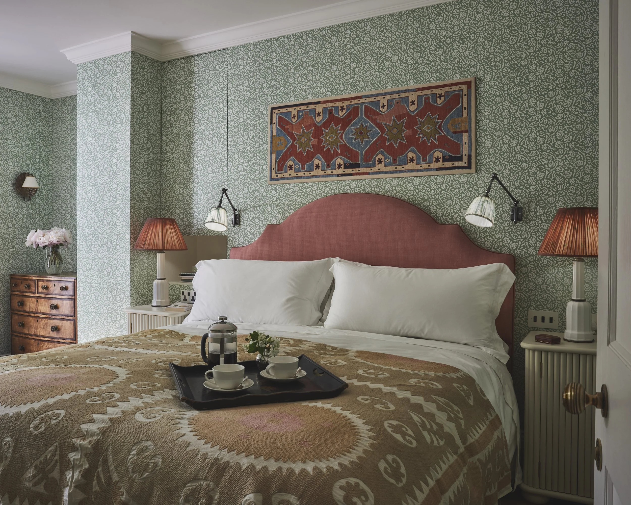 Kensington main bedroom, with patterned wallpaper and fabric headboard