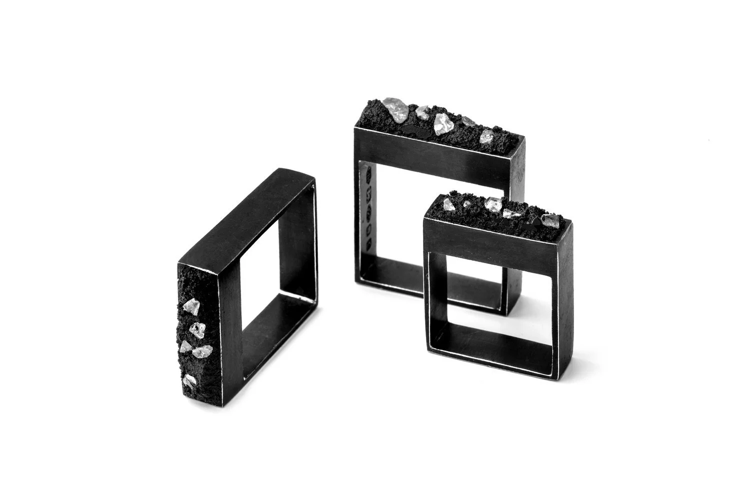 Photography of black and crystal contemporary rings