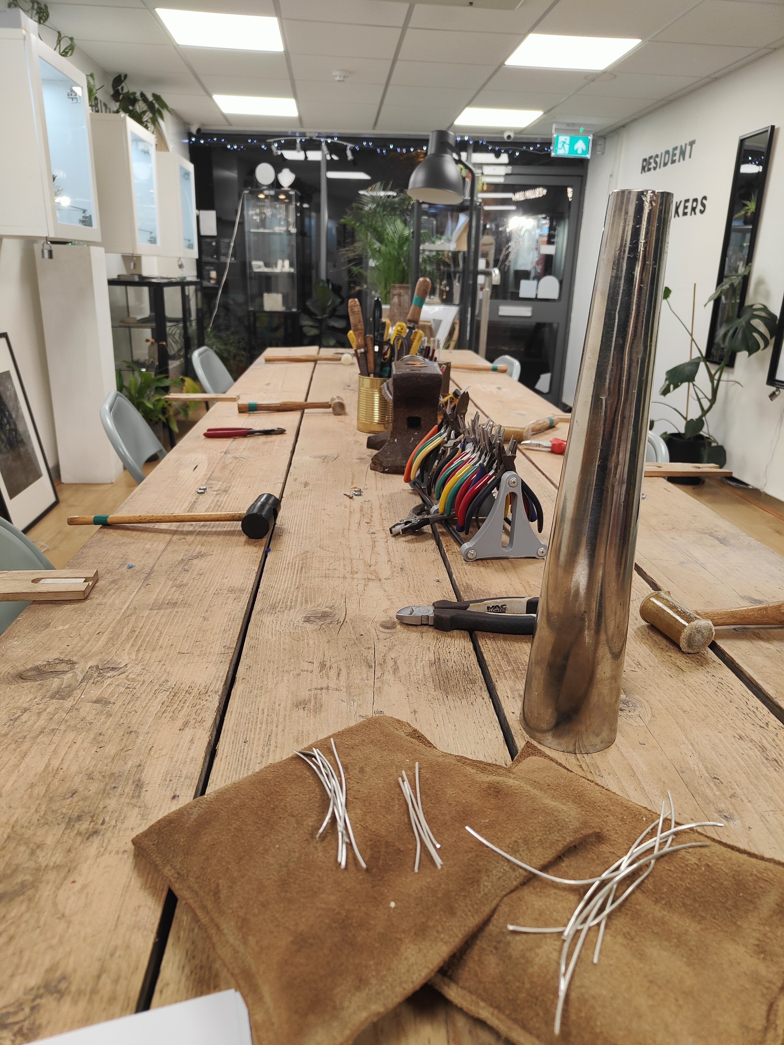 A workshop table set up ready to make silver hoop earrings