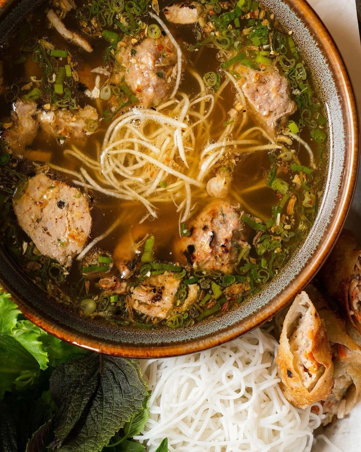 Nope! It&rsquo;s not Pho 🍜, its another MVP of Hanoi. Bun Cha Hanoi. Grilled pork patties and shoulder, crispy spring rolls, noods, fresh herbs &amp; lettuce. BIG flavors.