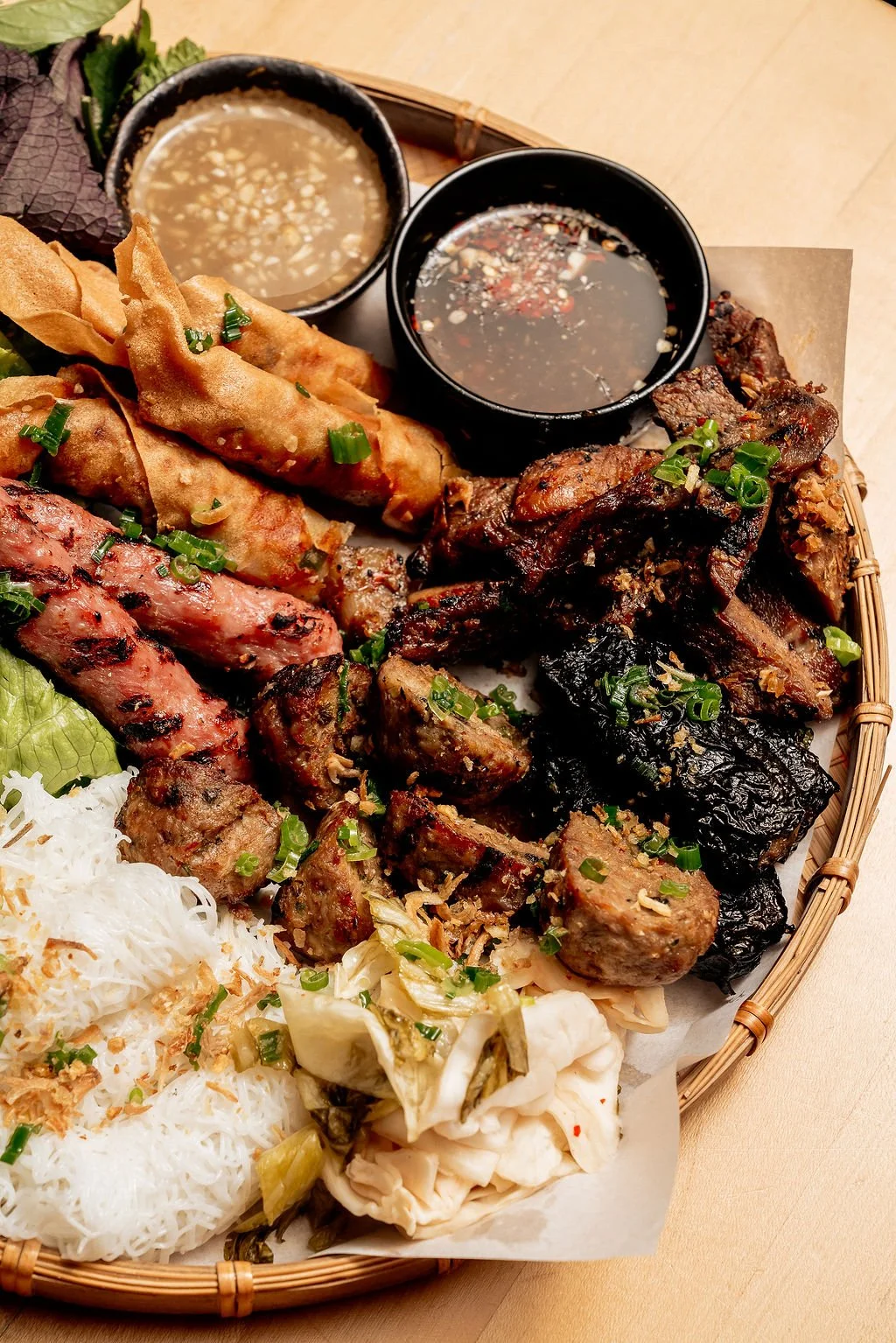 Grilled Meat Platter  |  Marinated pork shoulder, crispy shrimp roll, pork sausage skewers, bò lá lốt grilled betel wrap pork & beef sausage, bánh hối vermicelli rice noodle, bib lettuce, fresh herb & pickle veg