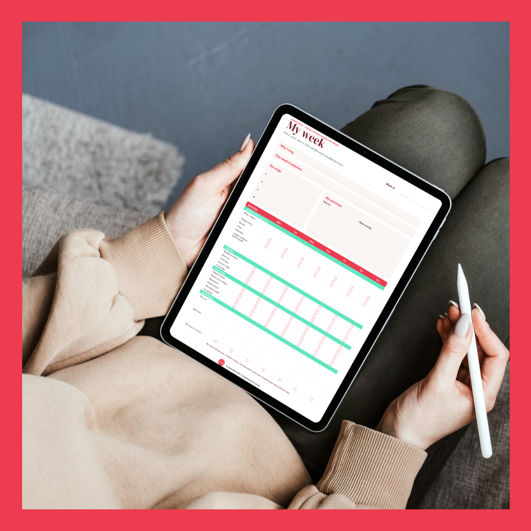 Person holding a tablet displaying a weekly planner while holding a white stylus