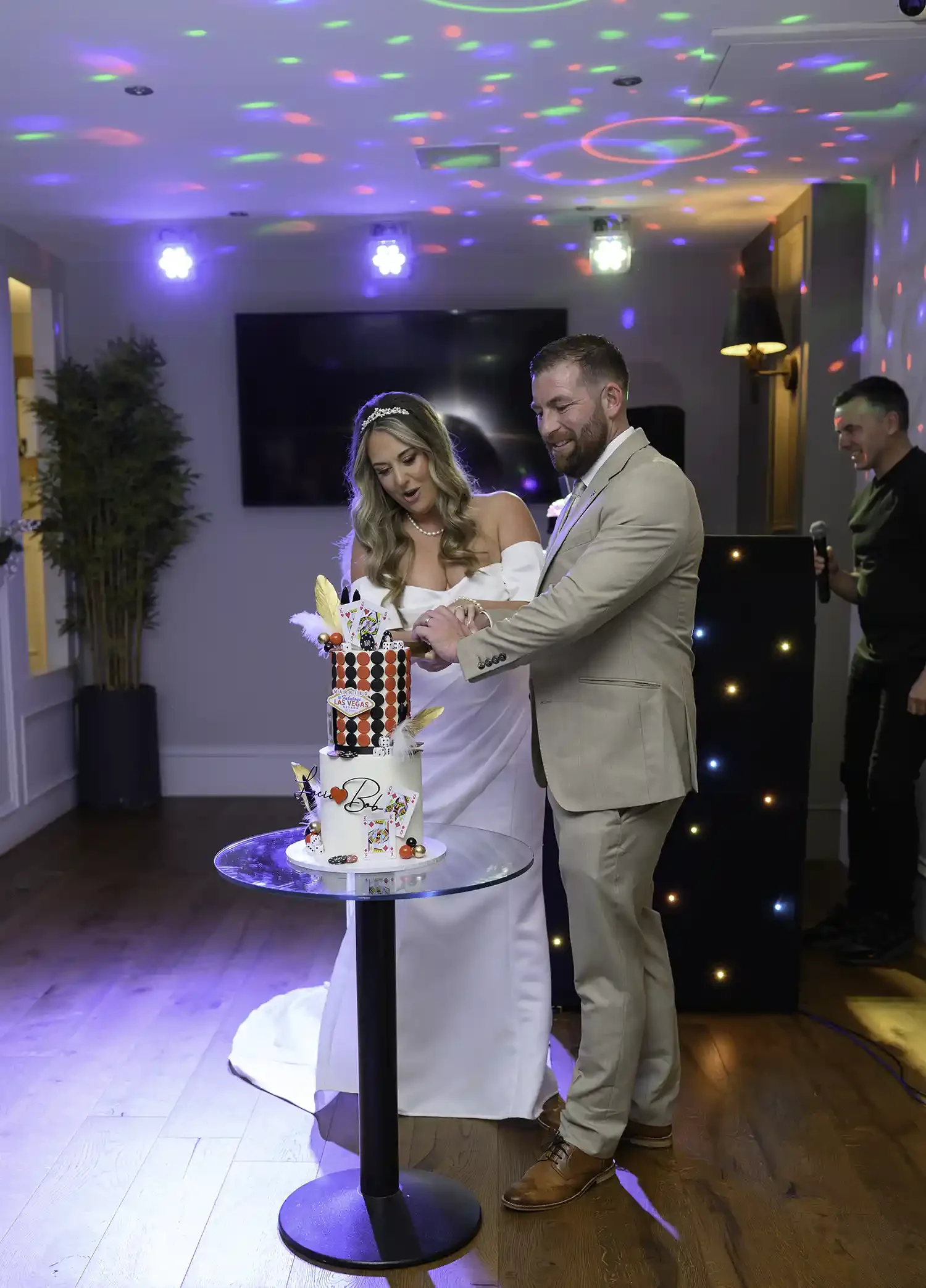 Bride and groom cutting their Las Vegas themed wedding cake during reception at The Stravaig Ayr