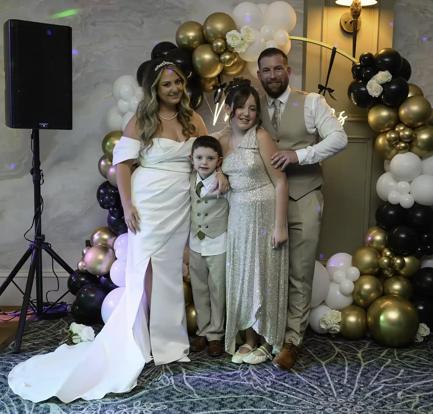Bride and groom with their children during wedding reception at The Stravaig in Ayr