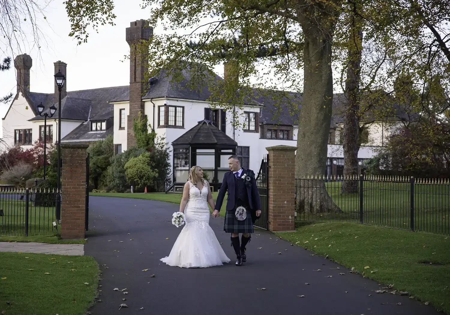 Bride and groom walking outside Western House Hotel in Ayr