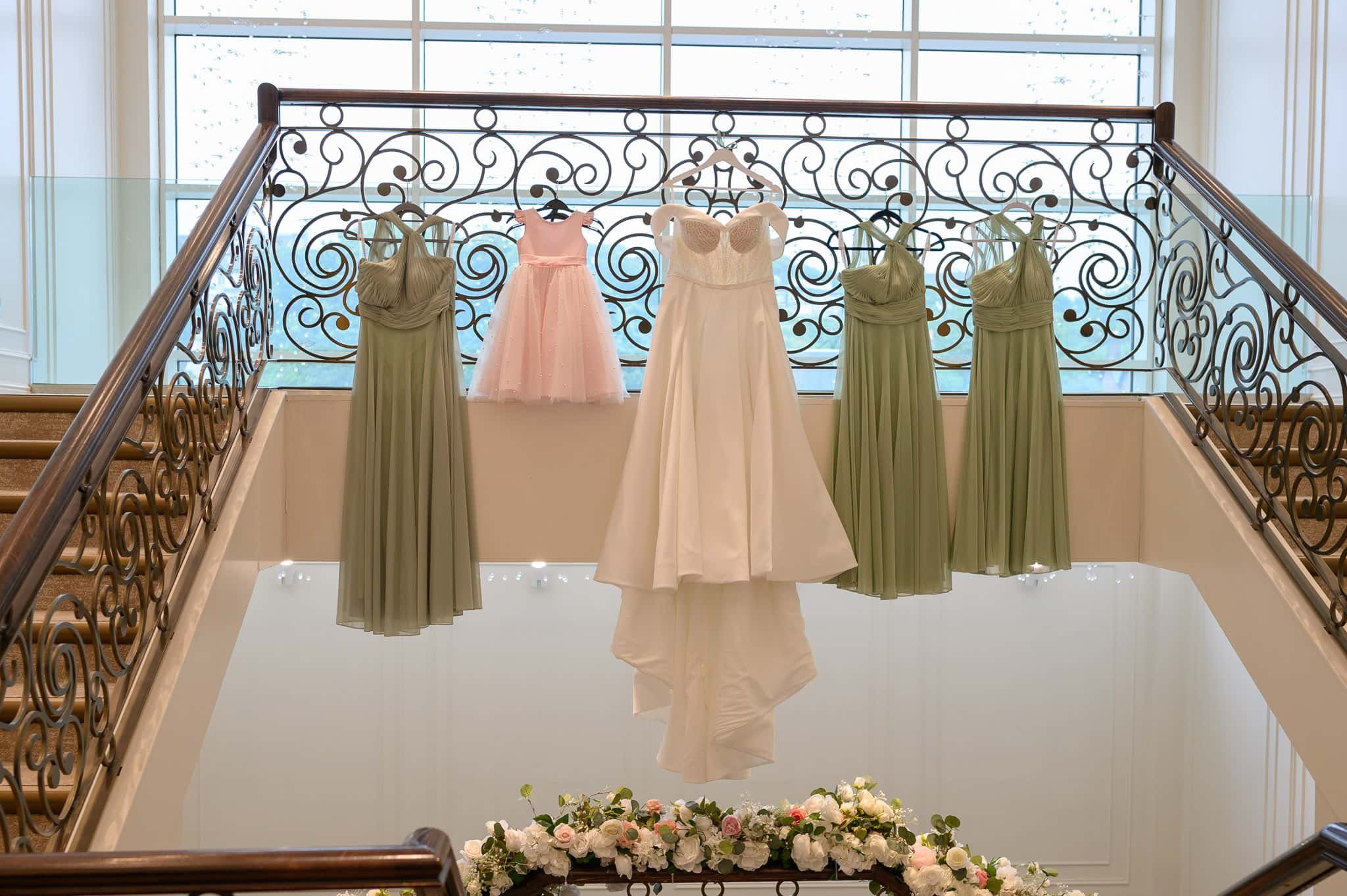Wedding dress and bridesmaid dresses displayed on staircase at Seamill Hydro Hotel in West Kilbride.
