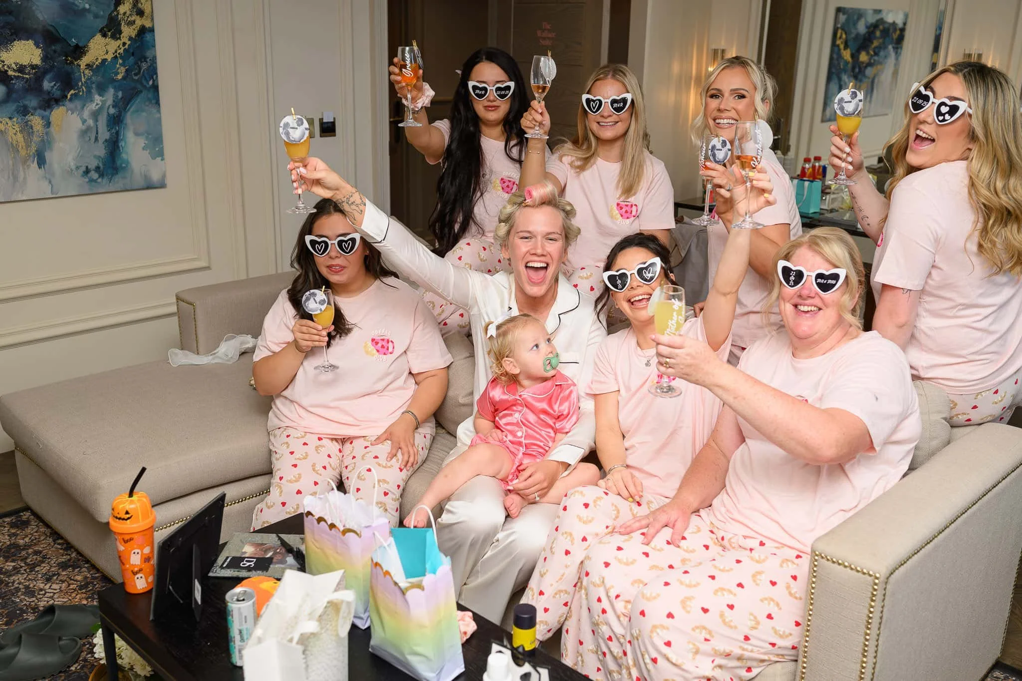 Bride and bridal party toasting drinks during wedding morning preparations at Brisbane House Hotel in Largs.