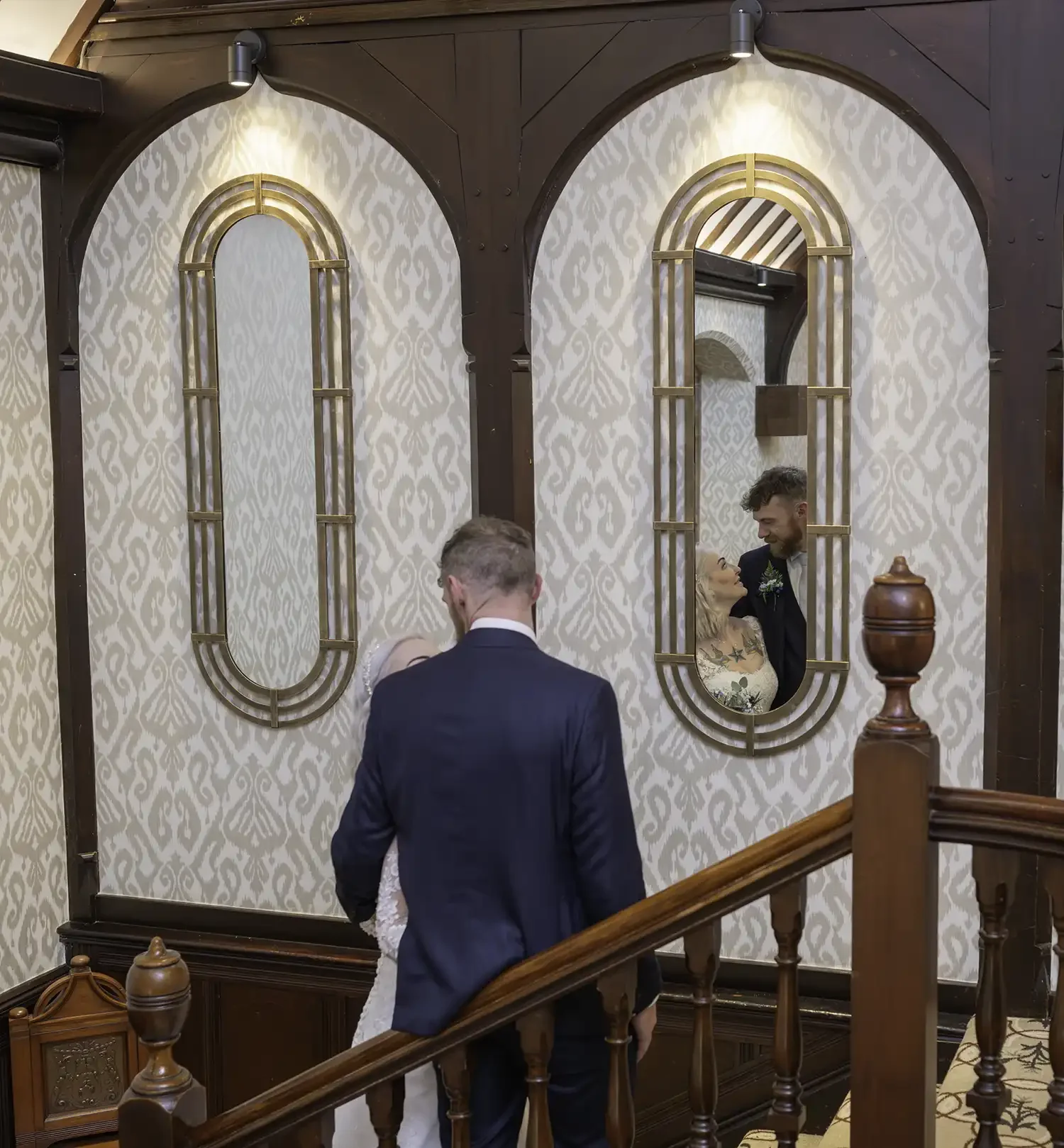 Bride and groom on staircase with mirror reflection at Piersland House Hotel in Troon