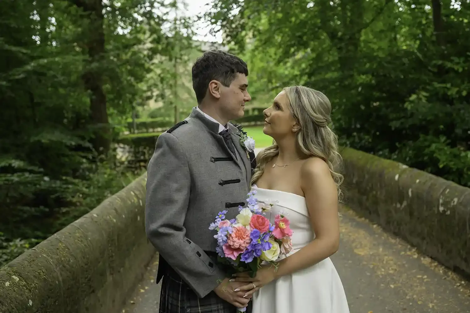 Bride and groom portrait on stone bridge at Dean Castle Country Park wedding in Kilmarnock Ayrshire