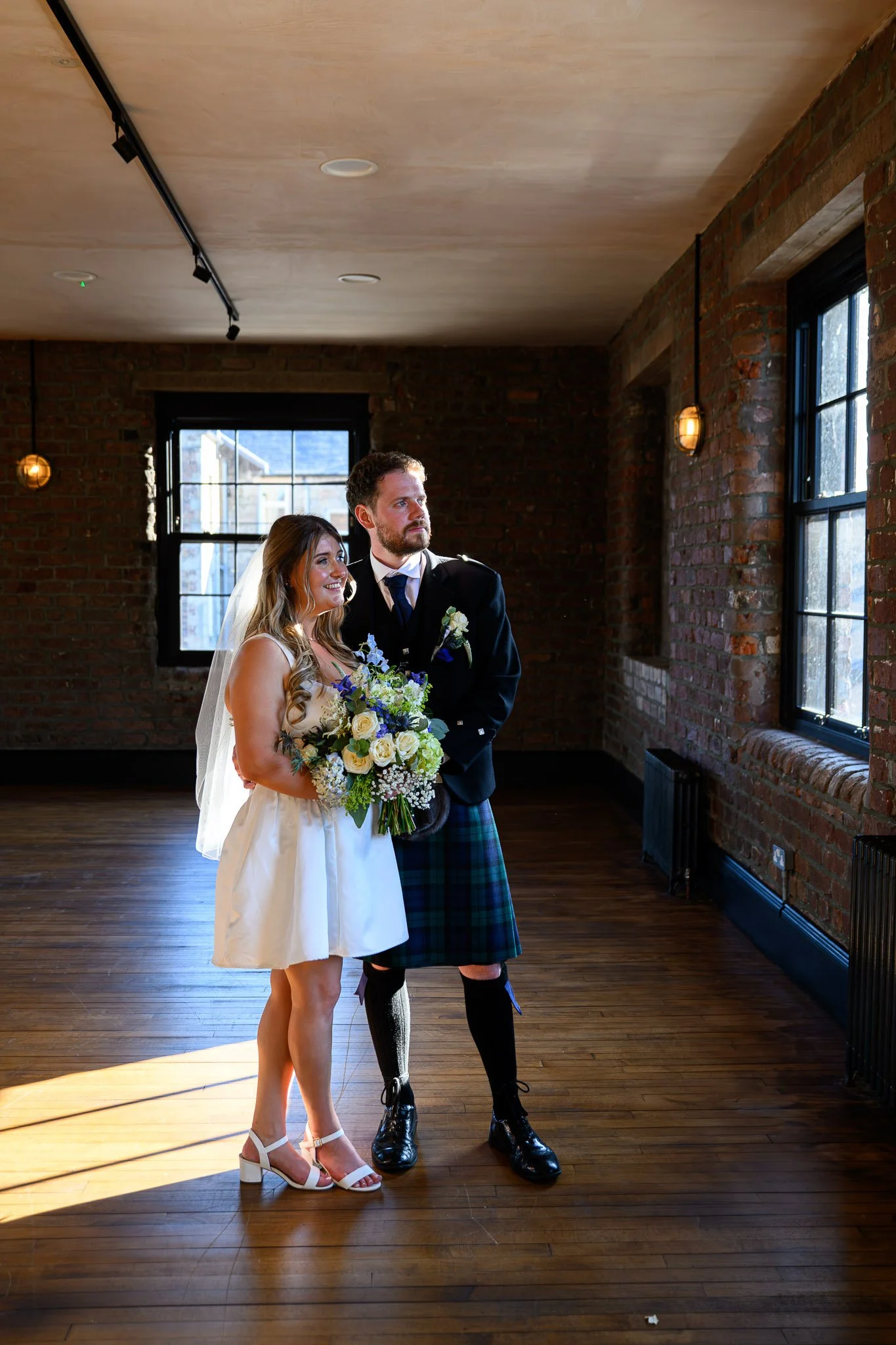 Natural wedding photography at The Engine Works in Glasgow showing couple portrait inside industrial venue