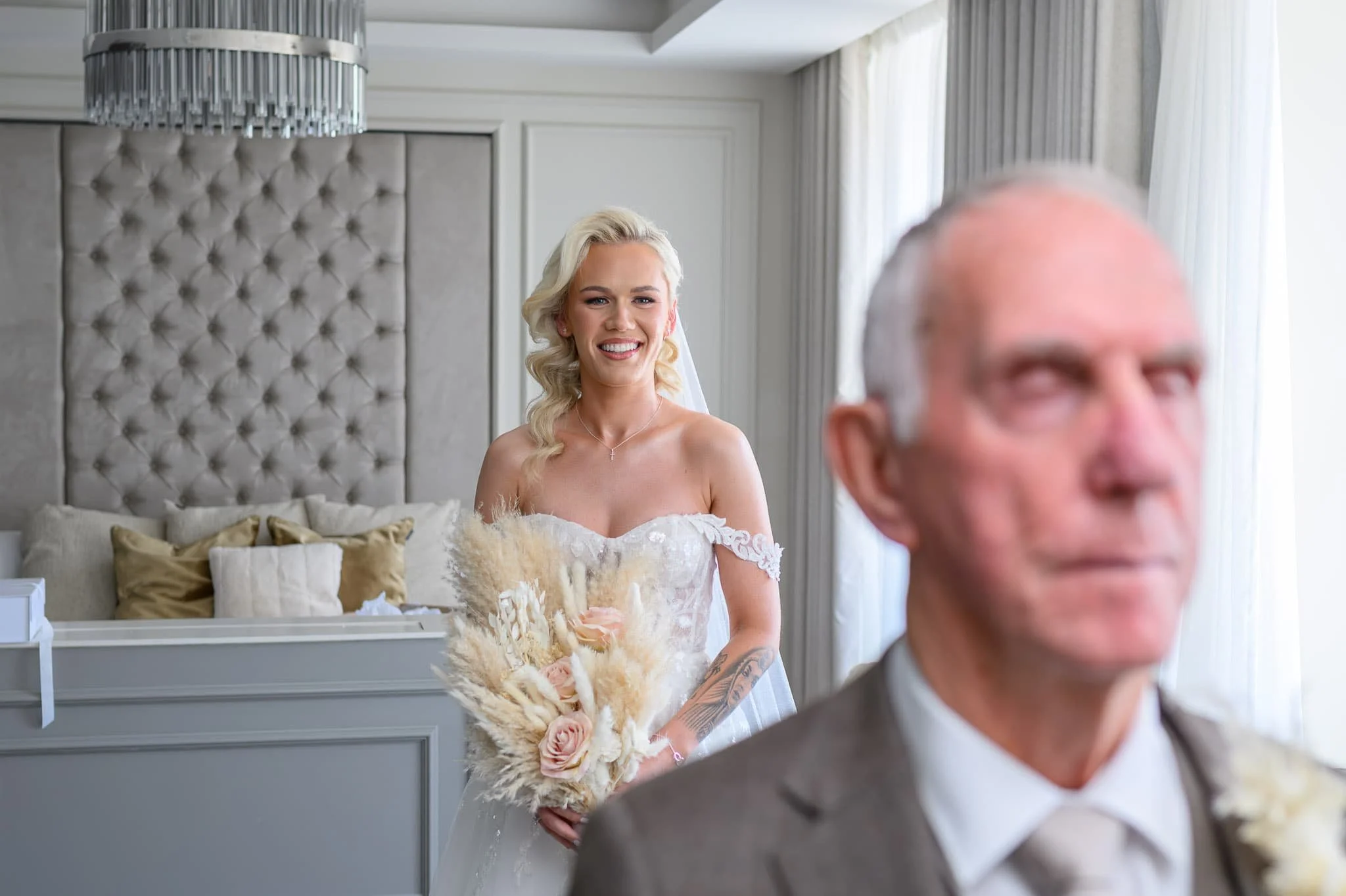 Bride standing behind her grandfather before a first look during wedding preparations at Brisbane House Hotel in Largs