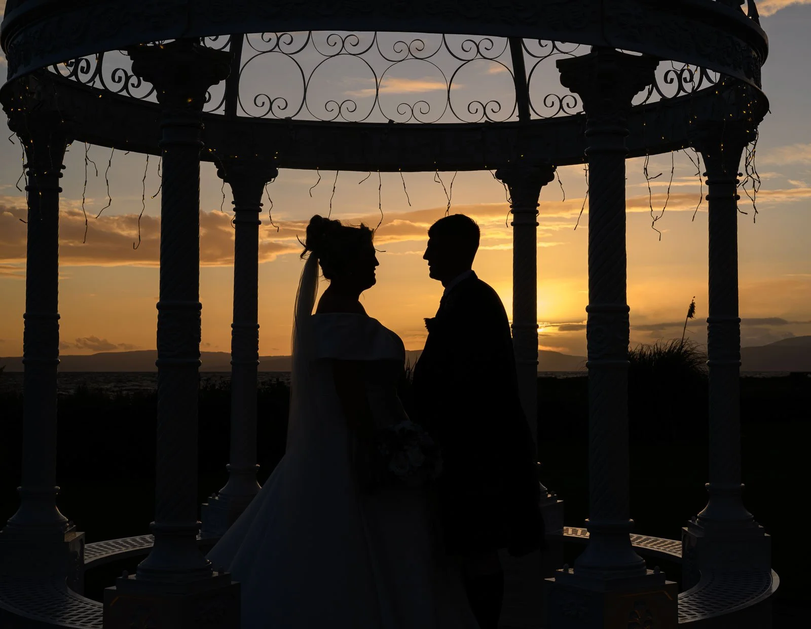 n intimate sunset wedding silhouette of a couple in a gazebo at a beautiful Ayrshire wedding venue