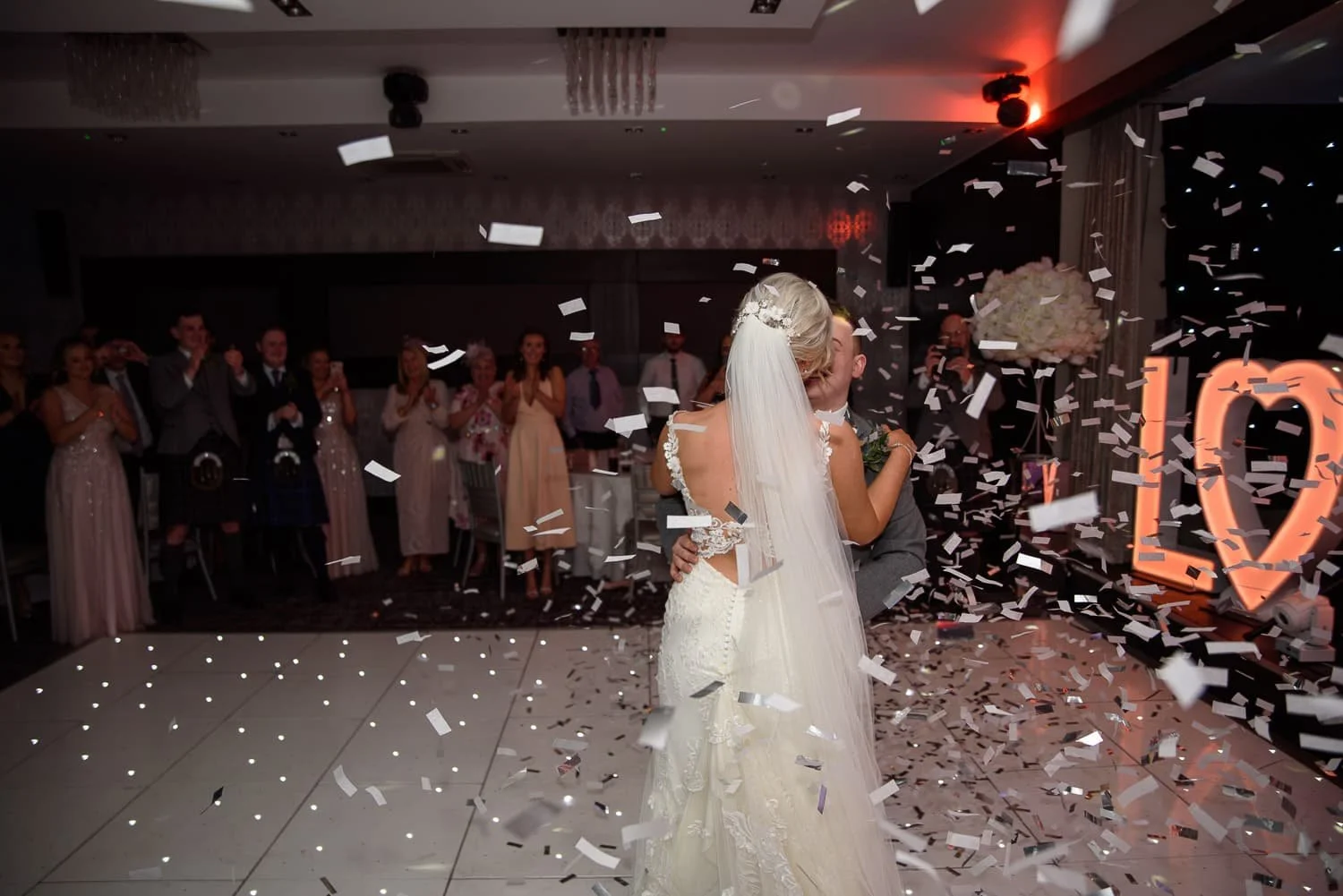 Bride and groom first dance with confetti cannon at The Carlton Hotel Prestwick wedding reception