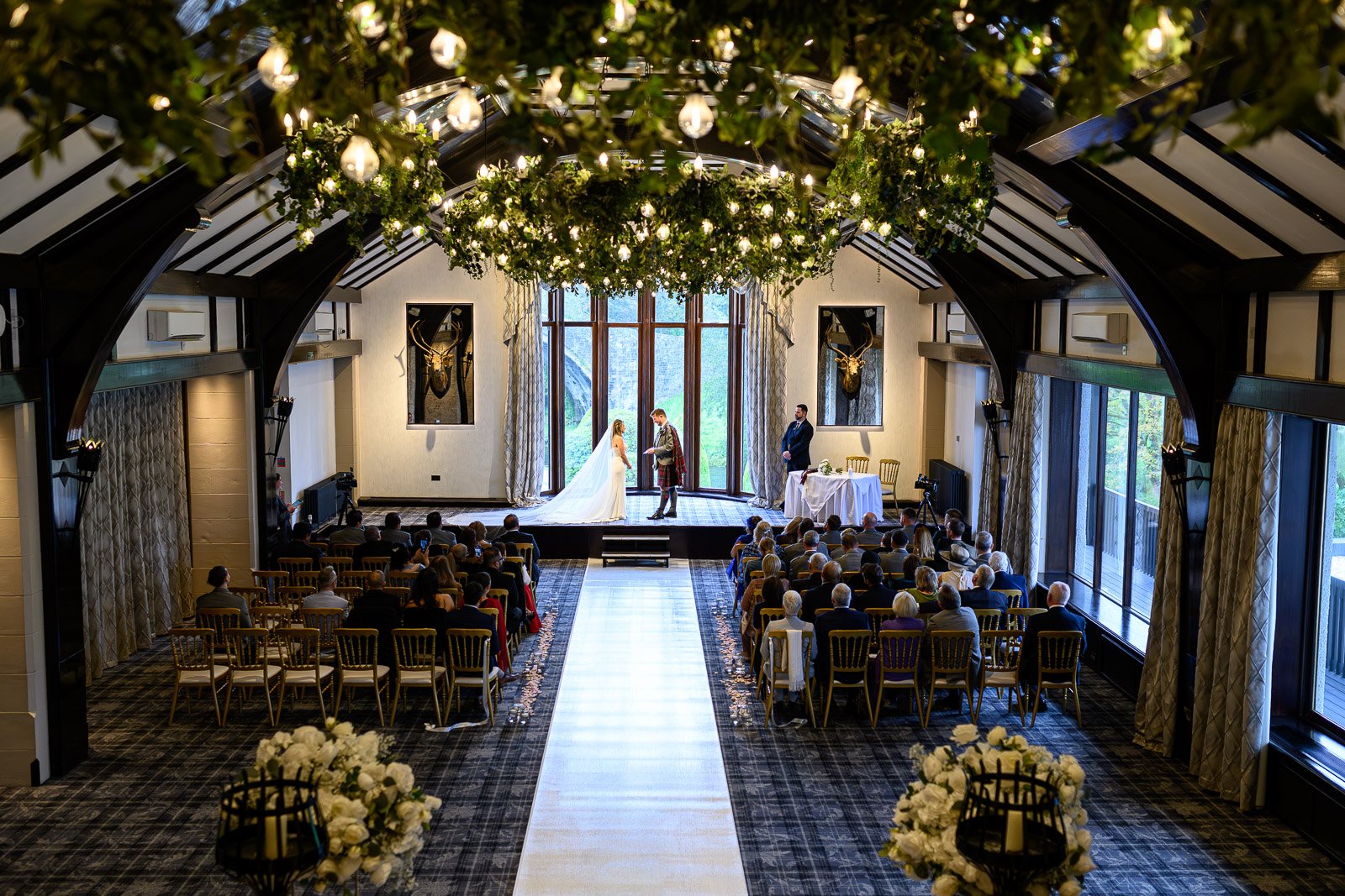 A luxury wedding ceremony taking place in the grand ballroom at Brig o' Doon House Hotel.