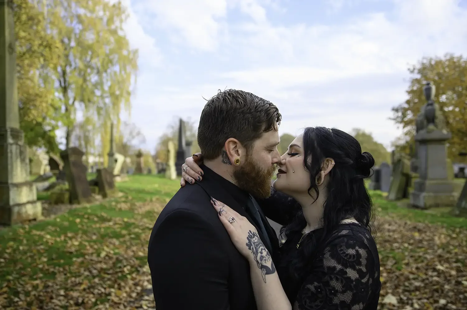 Bride and groom kissing at Burns Monument in Kilmarnock during autumn