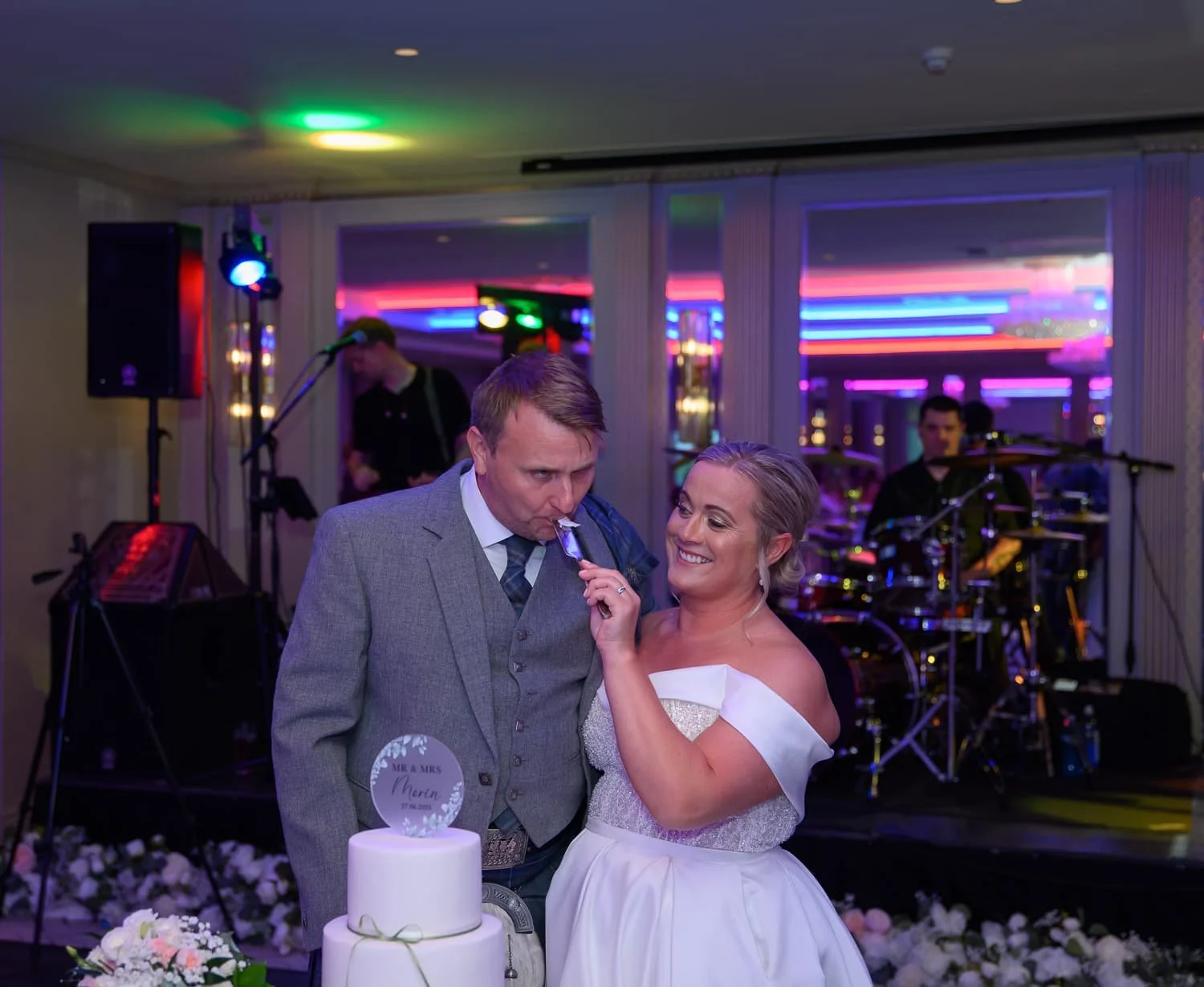 Bride feeding groom cake during their wedding reception at Seamill Hydro Hotel in West Kilbride.