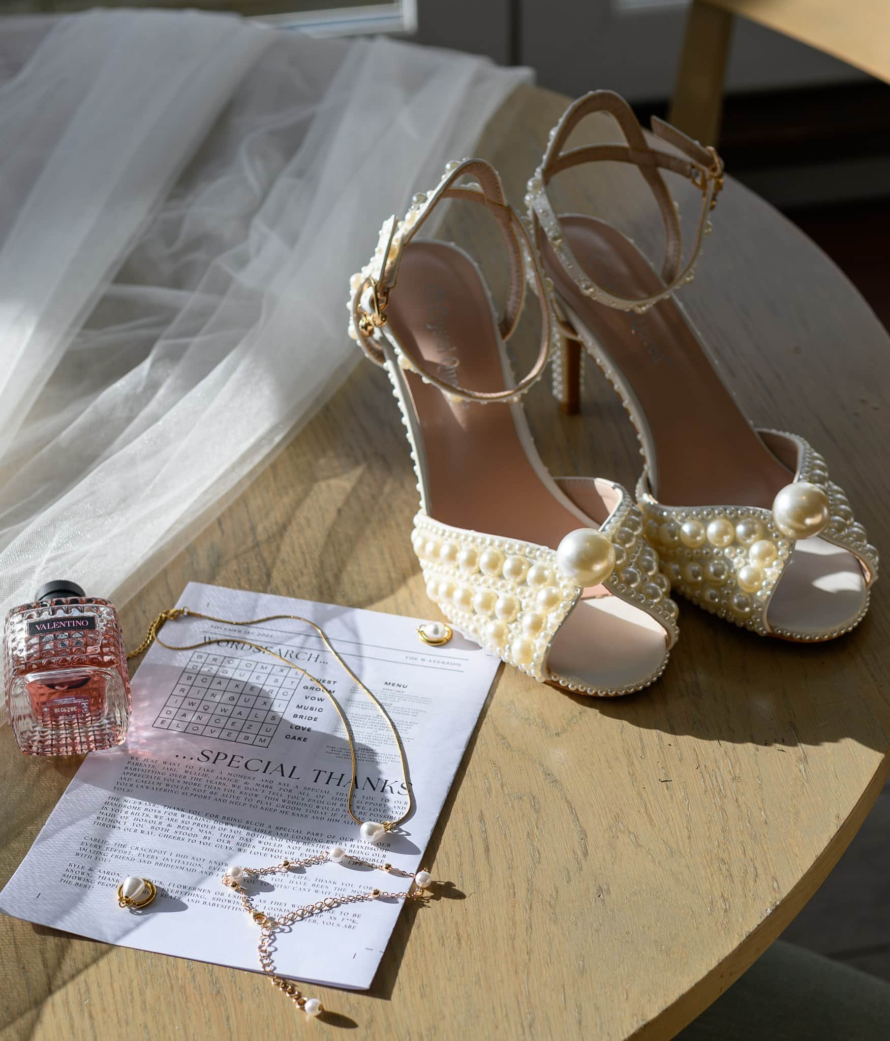 Bridal shoes, jewellery and perfume styled during morning preparations at The Waterside Hotel & Spa.